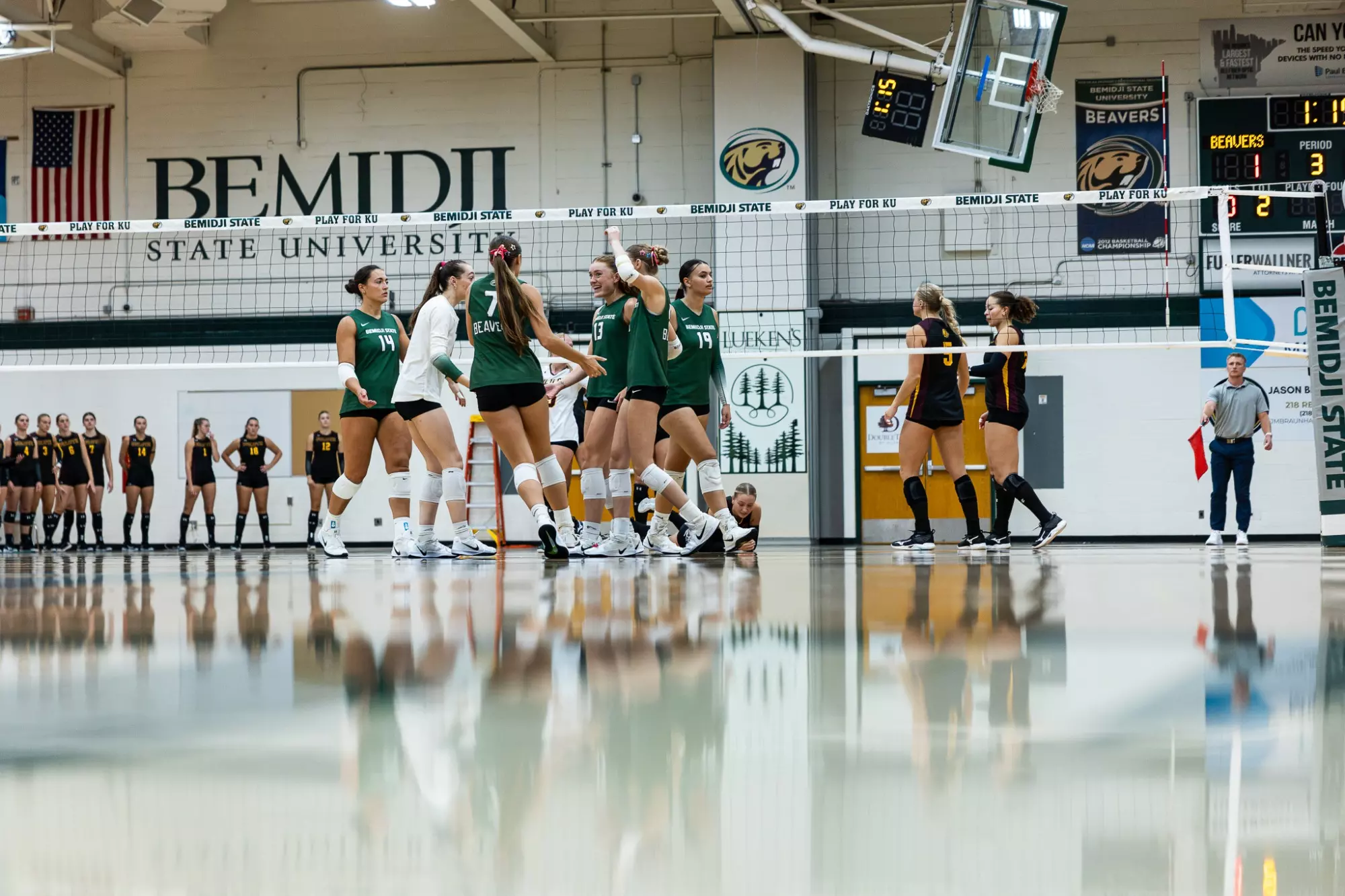 Bemidji State players gather near the net after a rally against Minnesota Duluth.