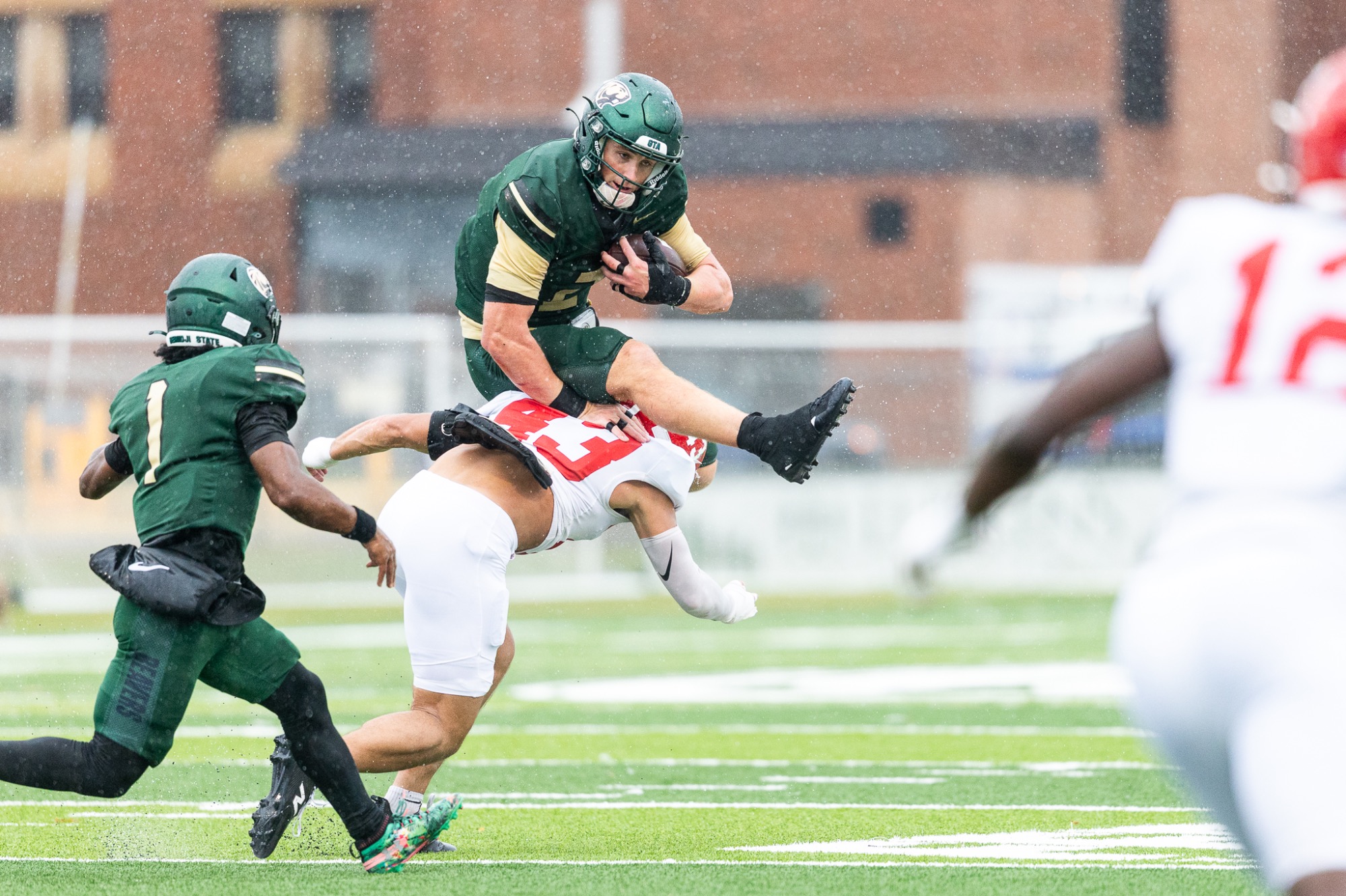 Connor Carver runs with the football while approaching Minot State defender No. 43 in the open field.