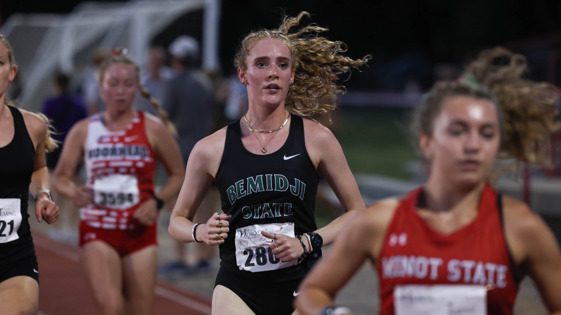 Sophie Rylance runs at the MSUM Dragon Twilight. She is wearing a black tank-top style jersey with 