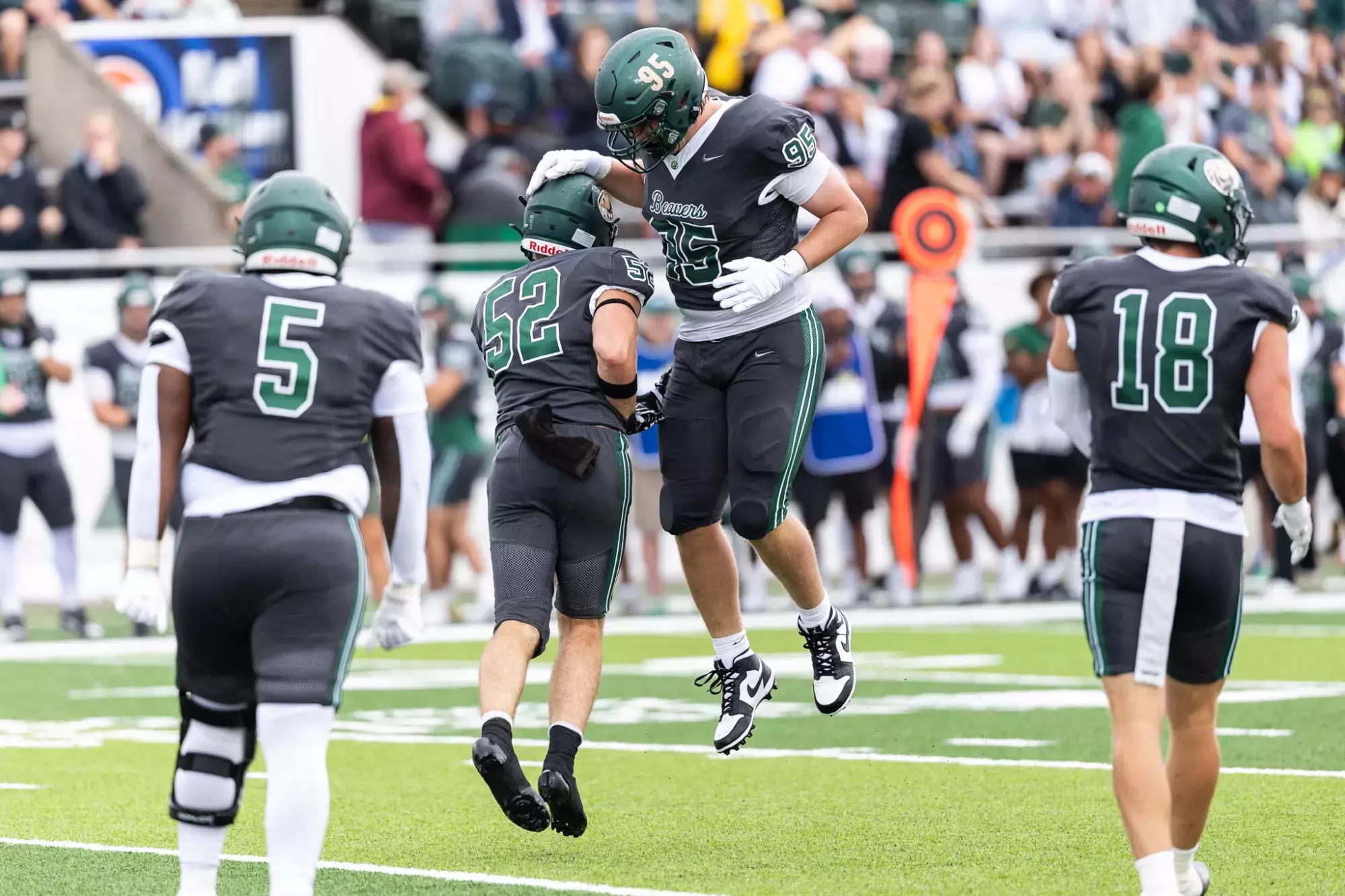Bemidji State player No. 95 jumps beside teammate No. 52 after a defensive play.
