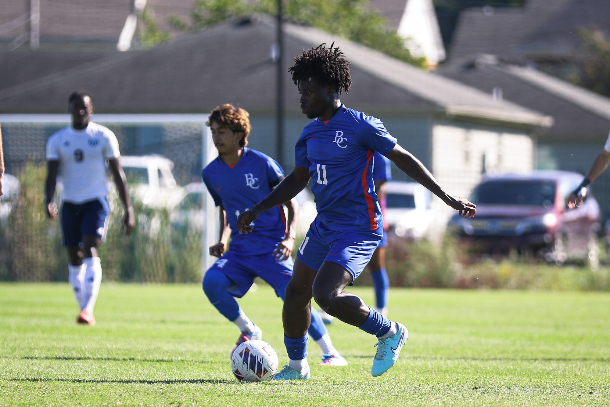 Tobore dribbles down field with Tomas behind