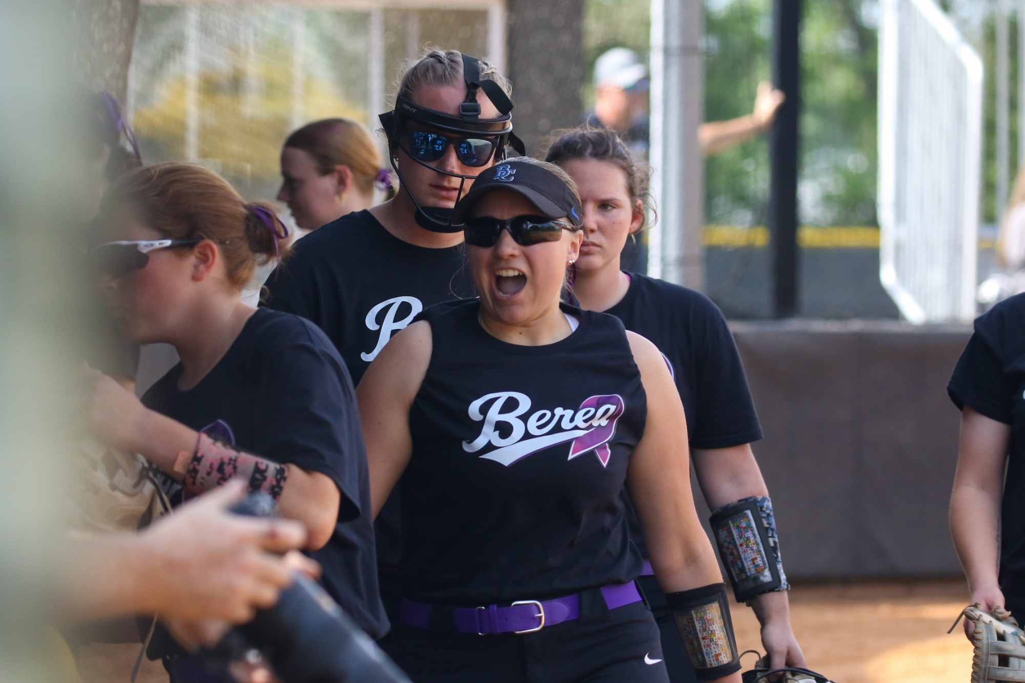 Softball team huddle with Rose S