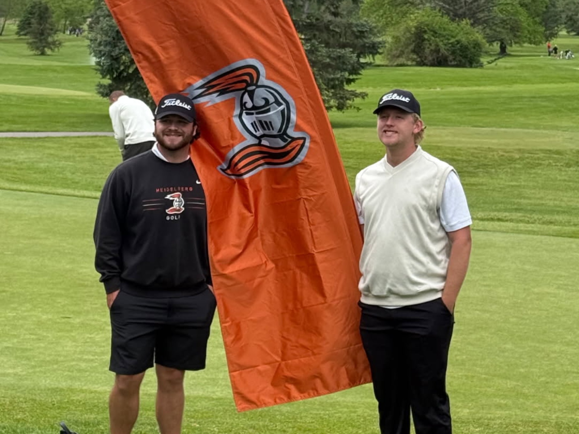 Ferdon and Niese pose by 'Berg banner at River Greens