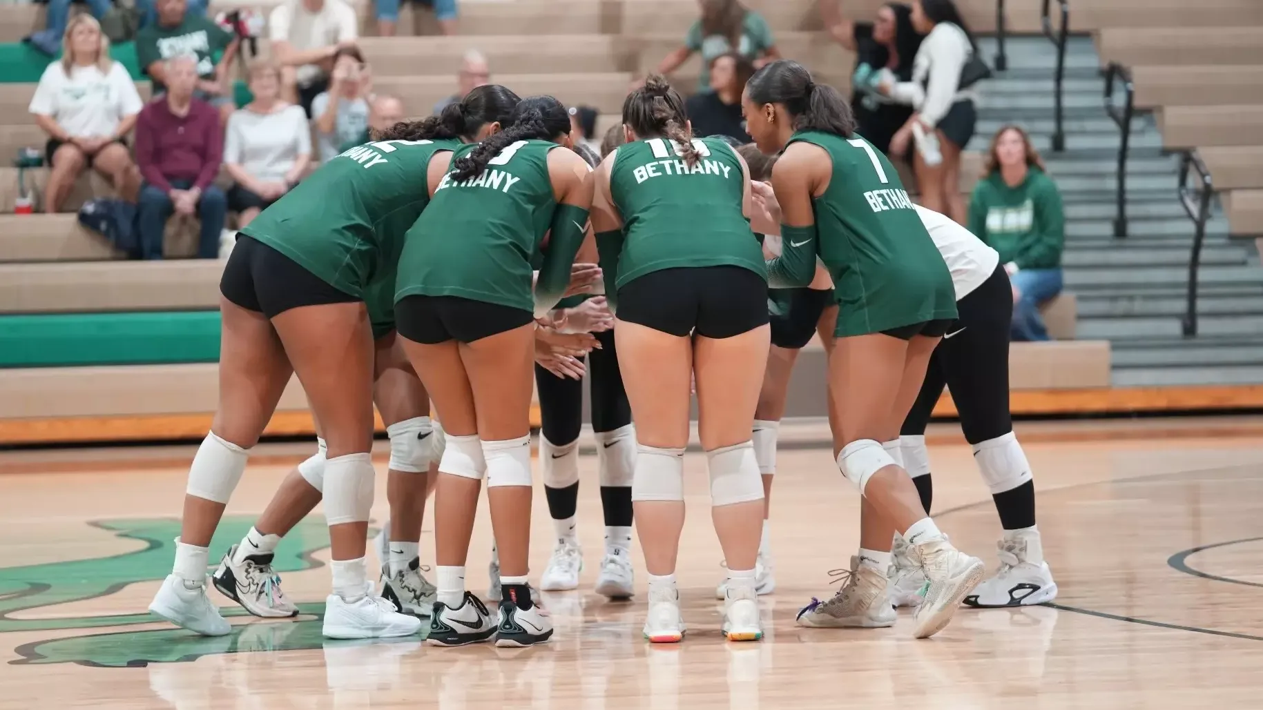 The women on the court regroup after giving up a point 