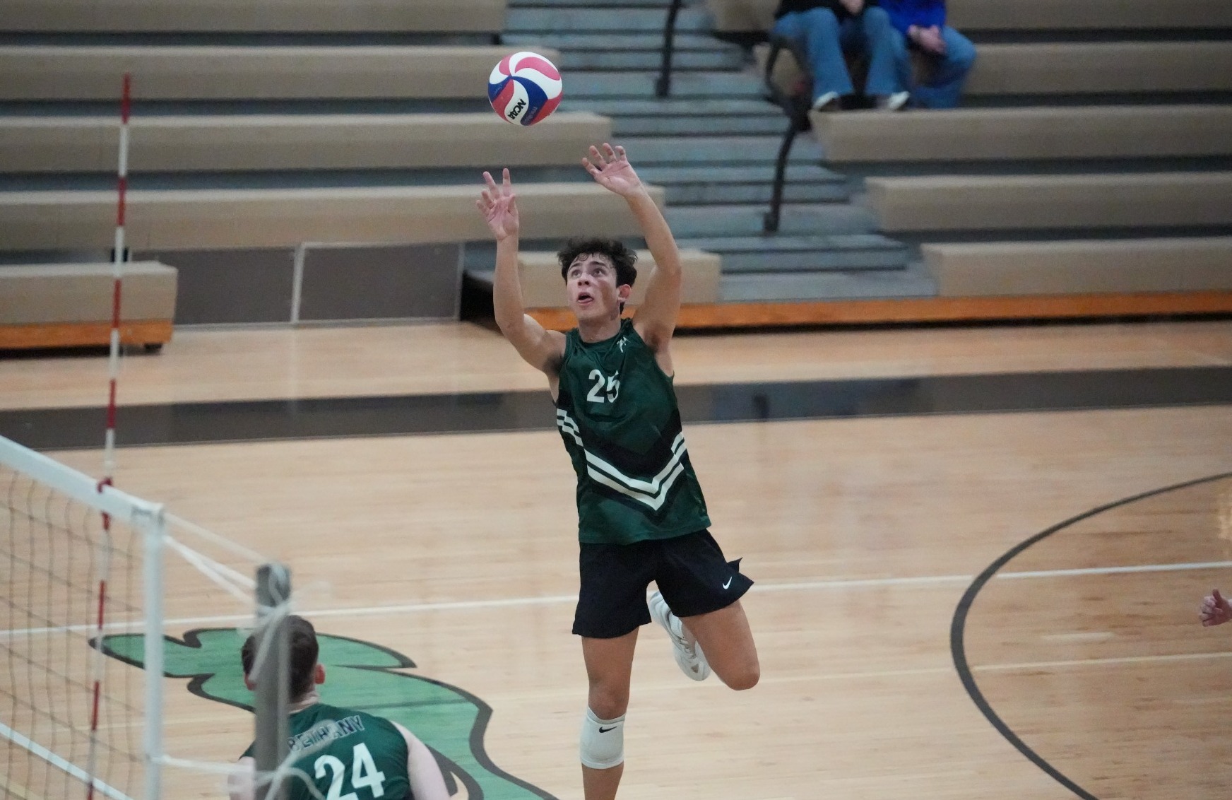Zachary Kay sending a free ball over the net
