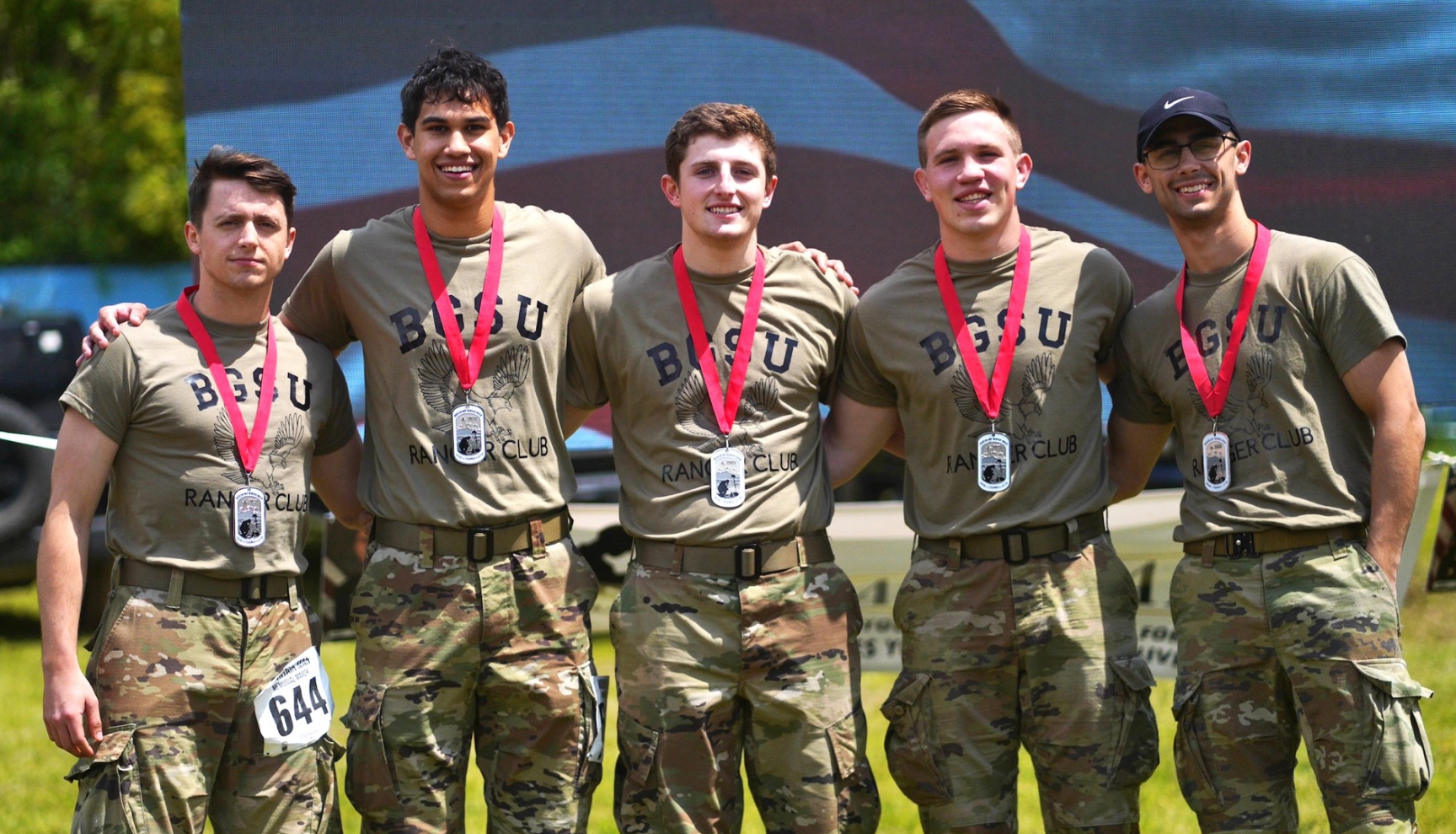 5 team members wearing ranger club tshirts standing in a line and smiling