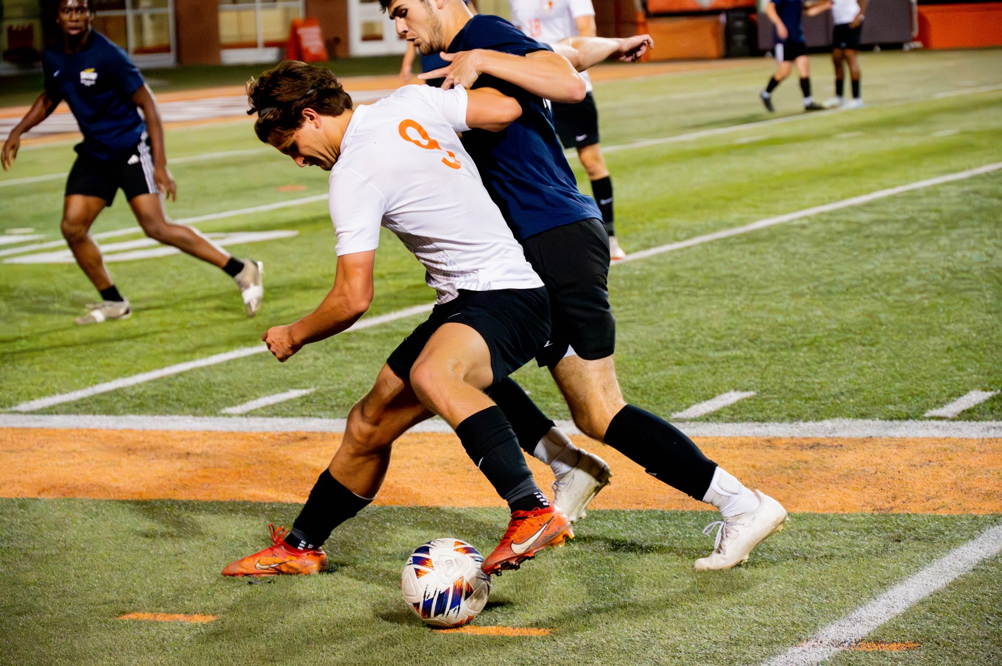 Michael Lindh tries to keep the ball away from the nearby Toledo players.