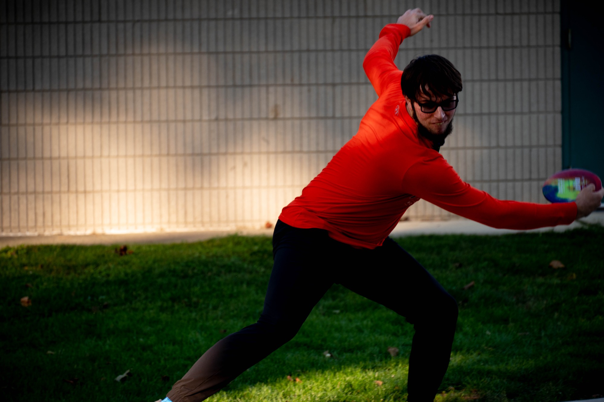A member of the Club Disk Golf team winds up for a long drive down hole 1.