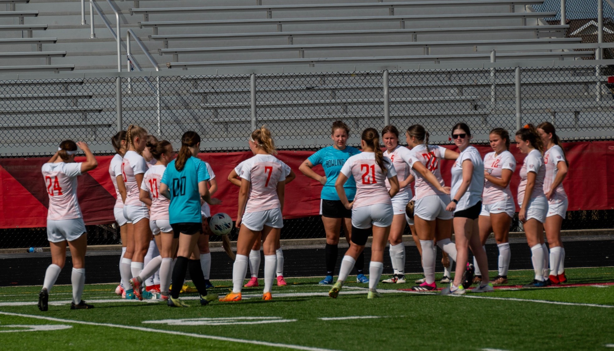 women's soccer in a team huddle