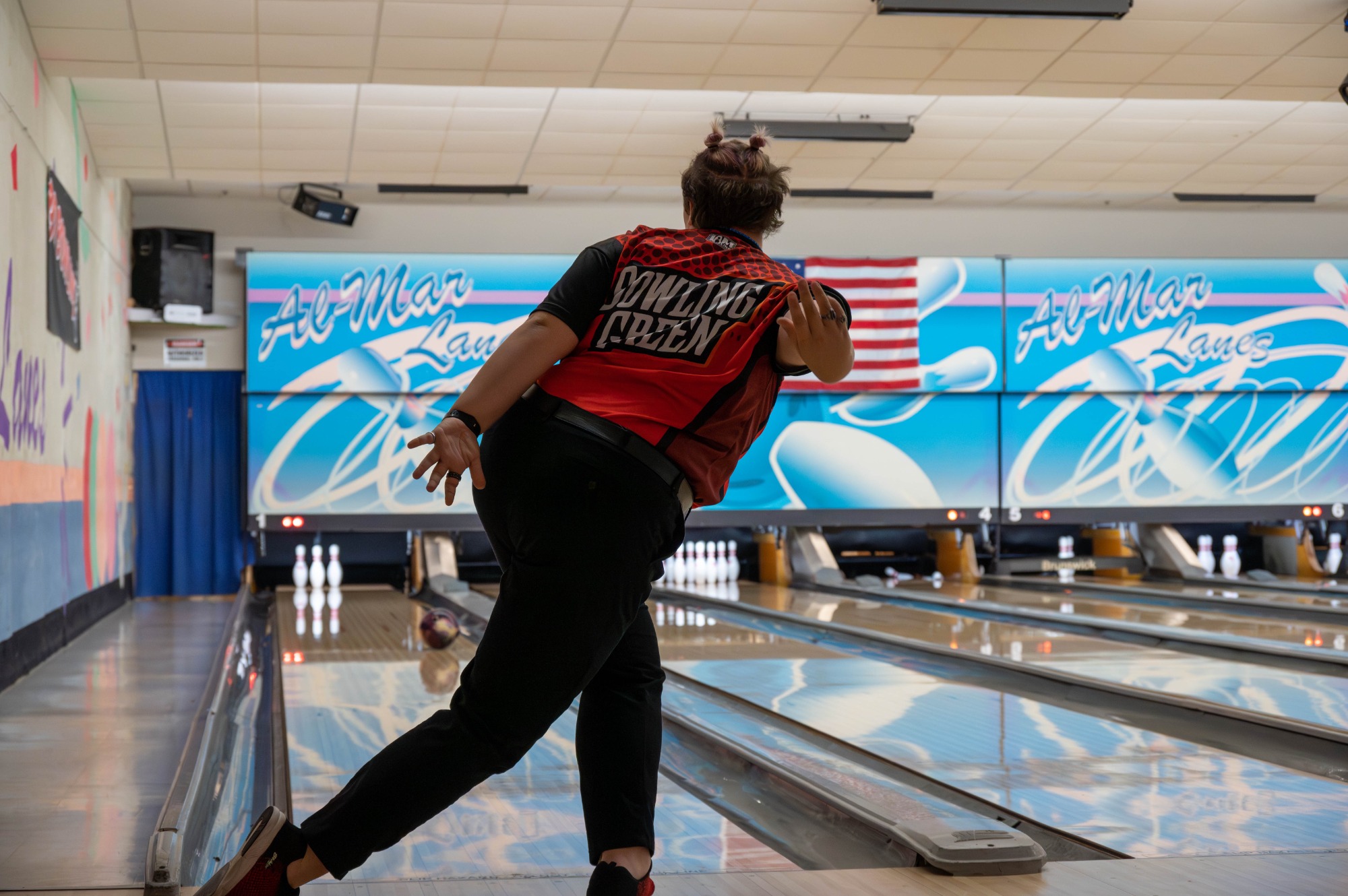 Member of the Women's Club Bowling team after throwing her ball down the lane.