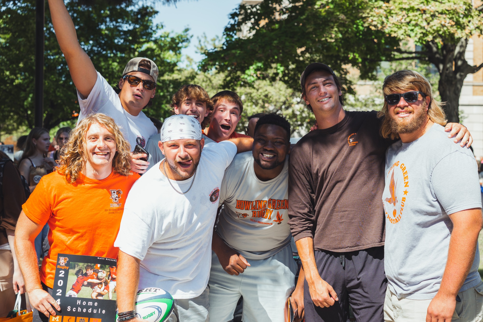 Eight members of the Men's Club Rugby team smile for a picture.