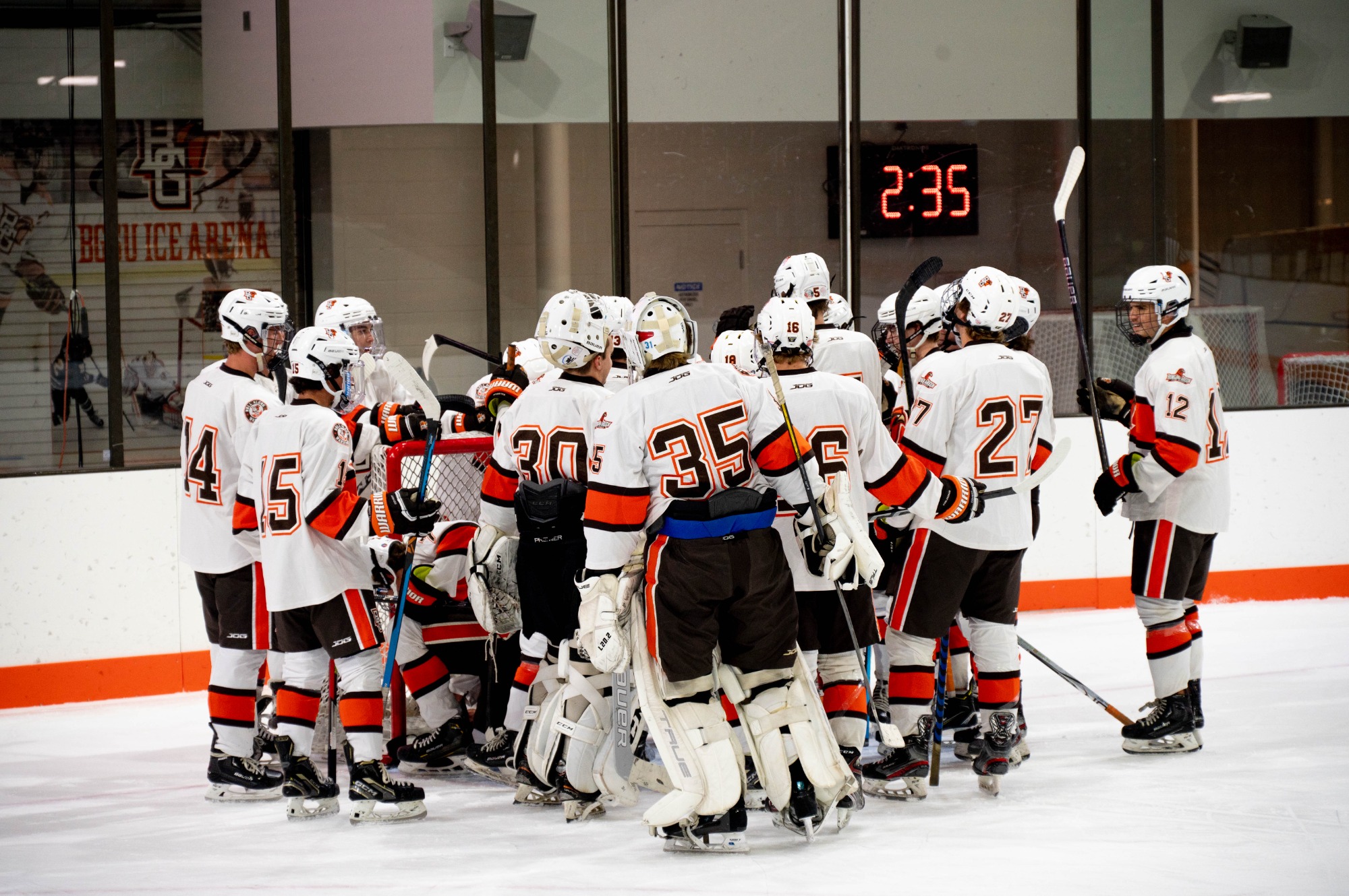 The Men's Club Hockey team circles up before starting their game. 