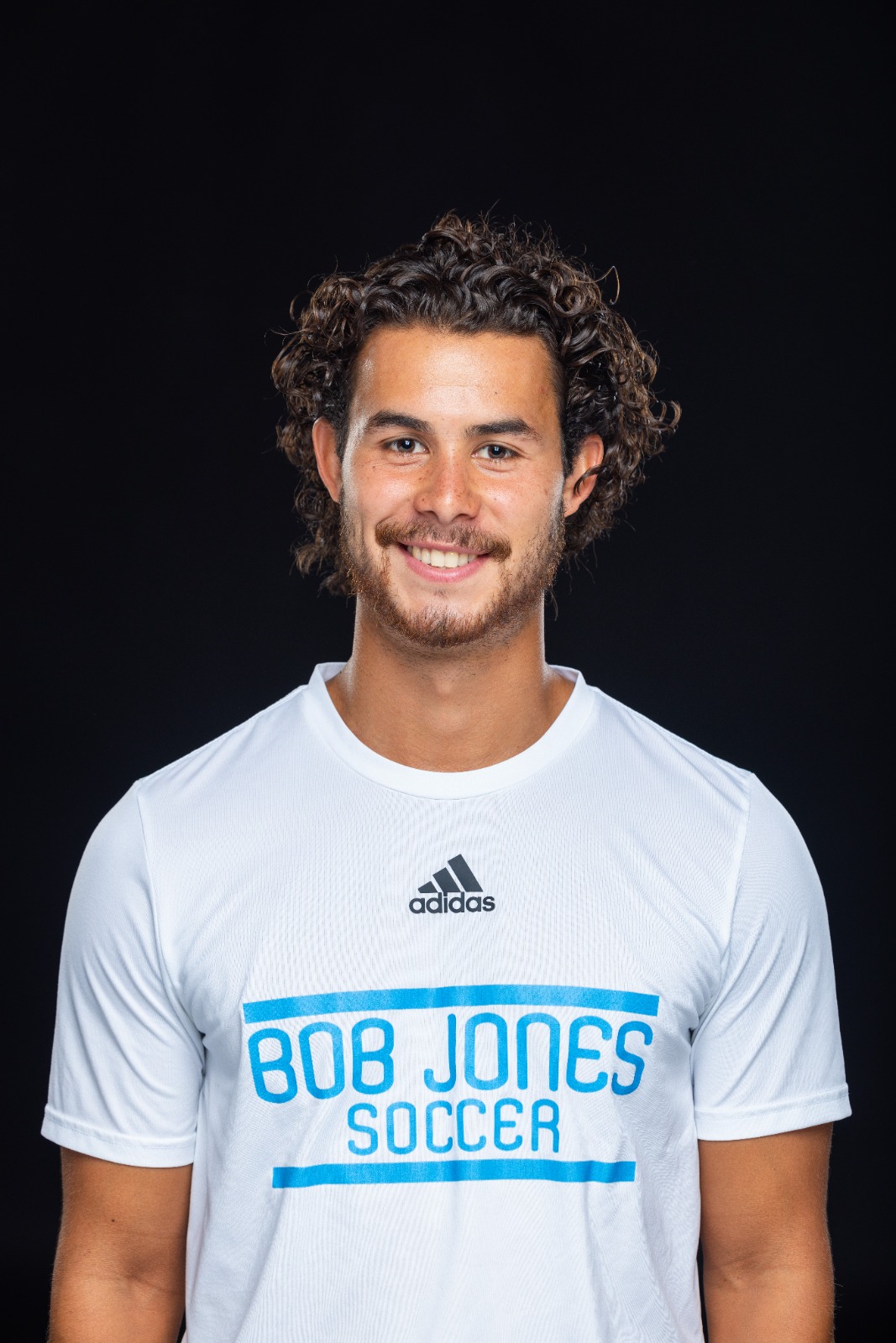 A member of the BJU Bruins roster poses for a headshot on a black background at Bob Jones University in Greenville, S.C., Monday, Aug. 18, 2025. (Photo by Derek Eckenroth)
