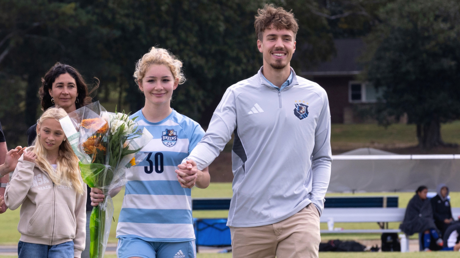 Francesca and Asher Aurednik holding hands and smiling