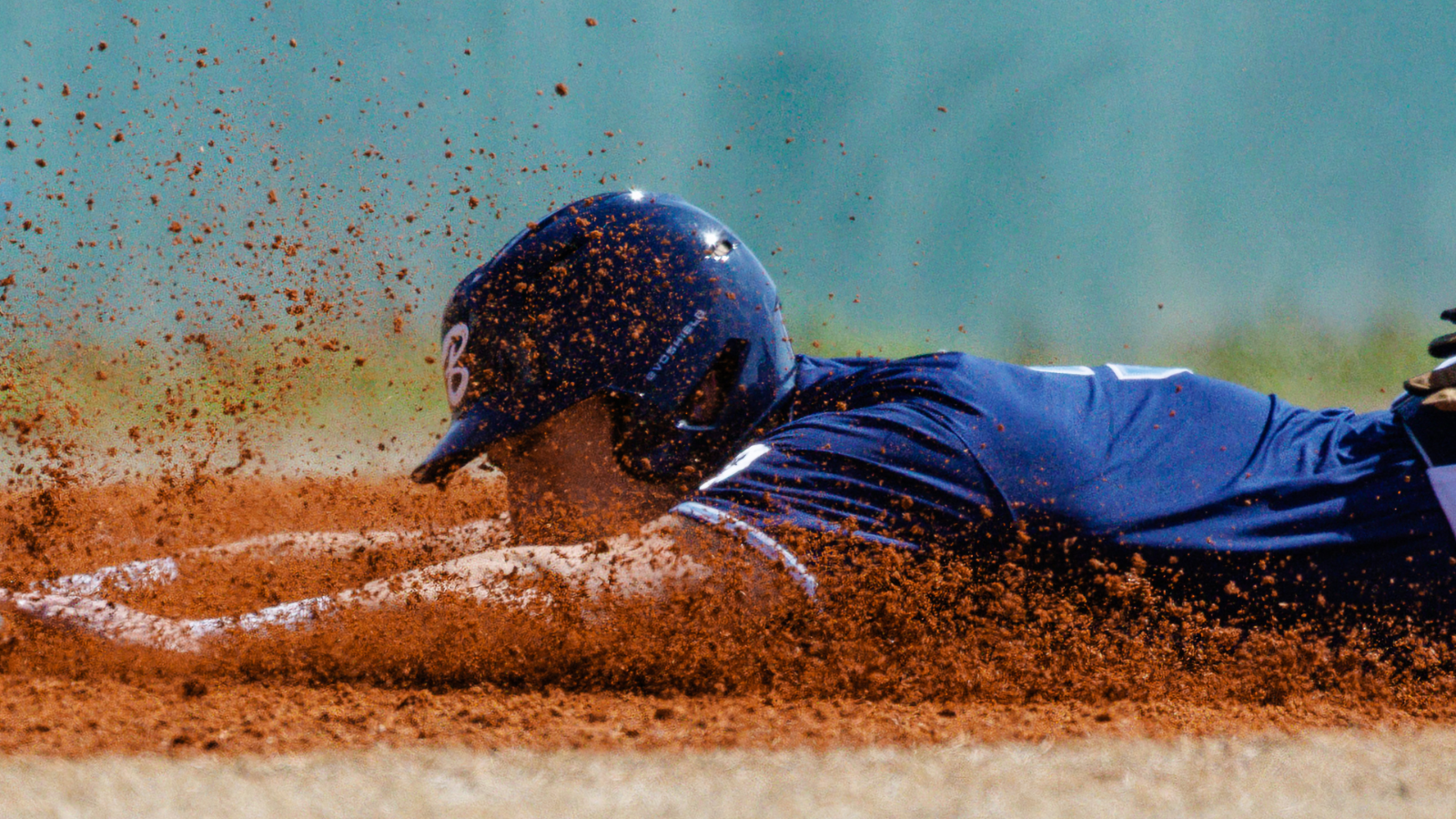 baseball player sliding into home plate