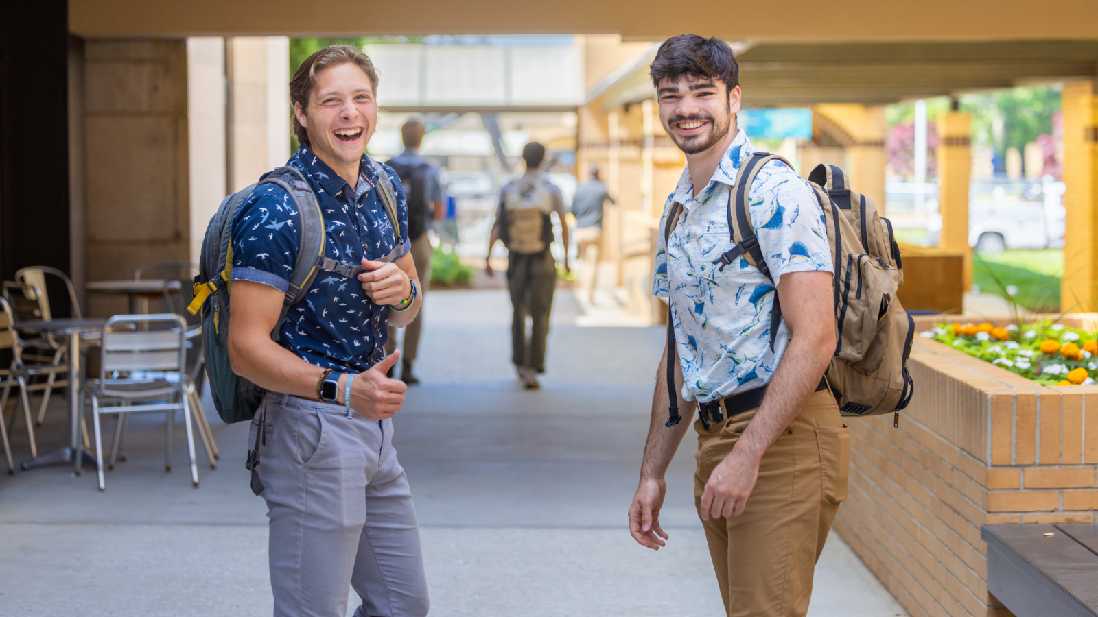 Two students smiling at the camera