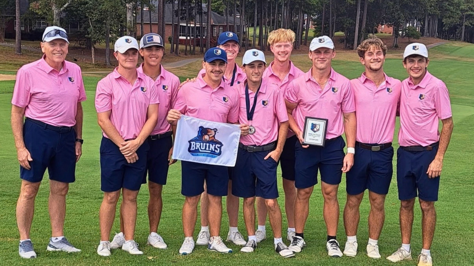 Bruins Golf Team in a line smiling at the camera