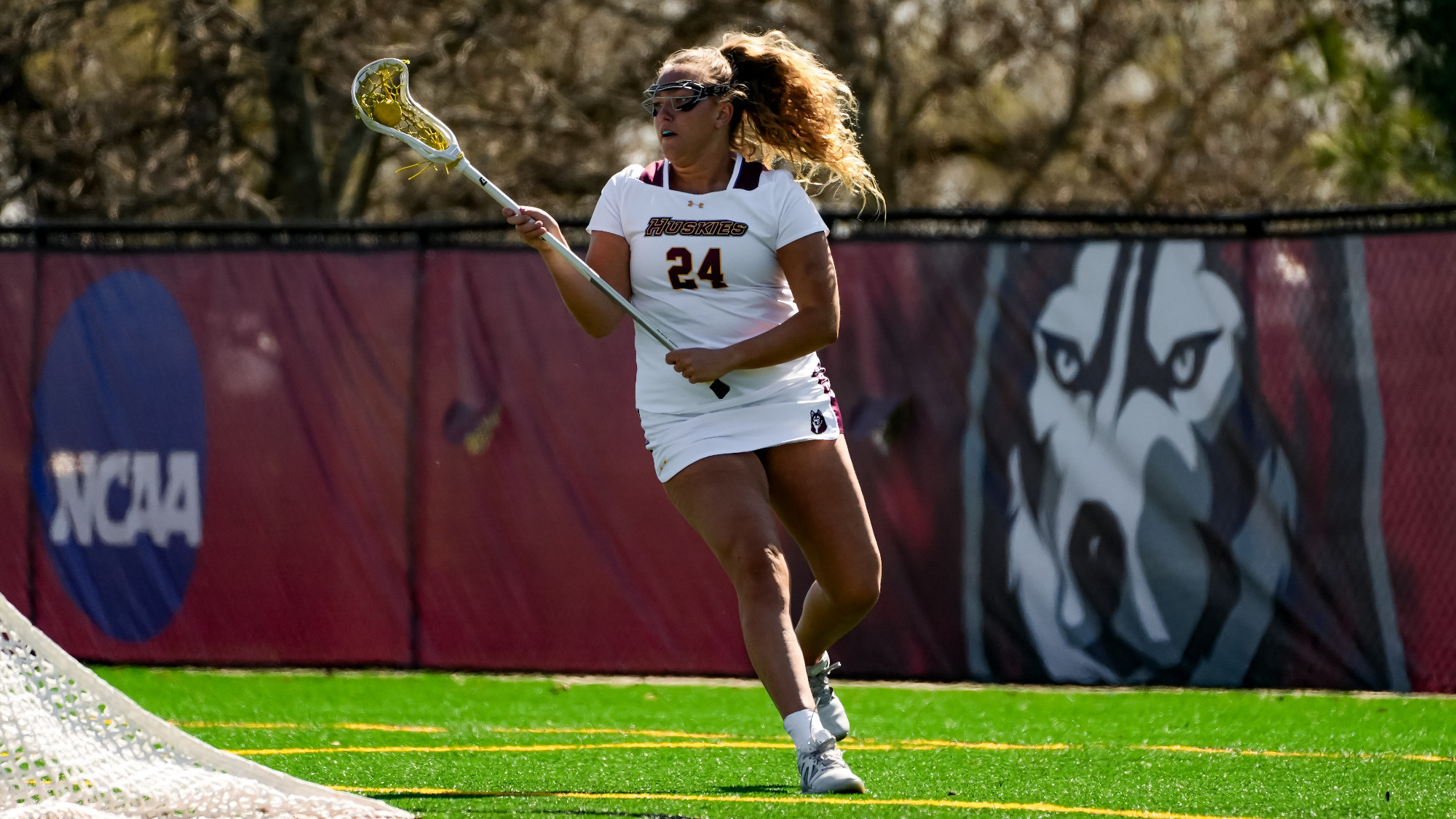 Kayla Stressman is behind the next with the ball in her stick.