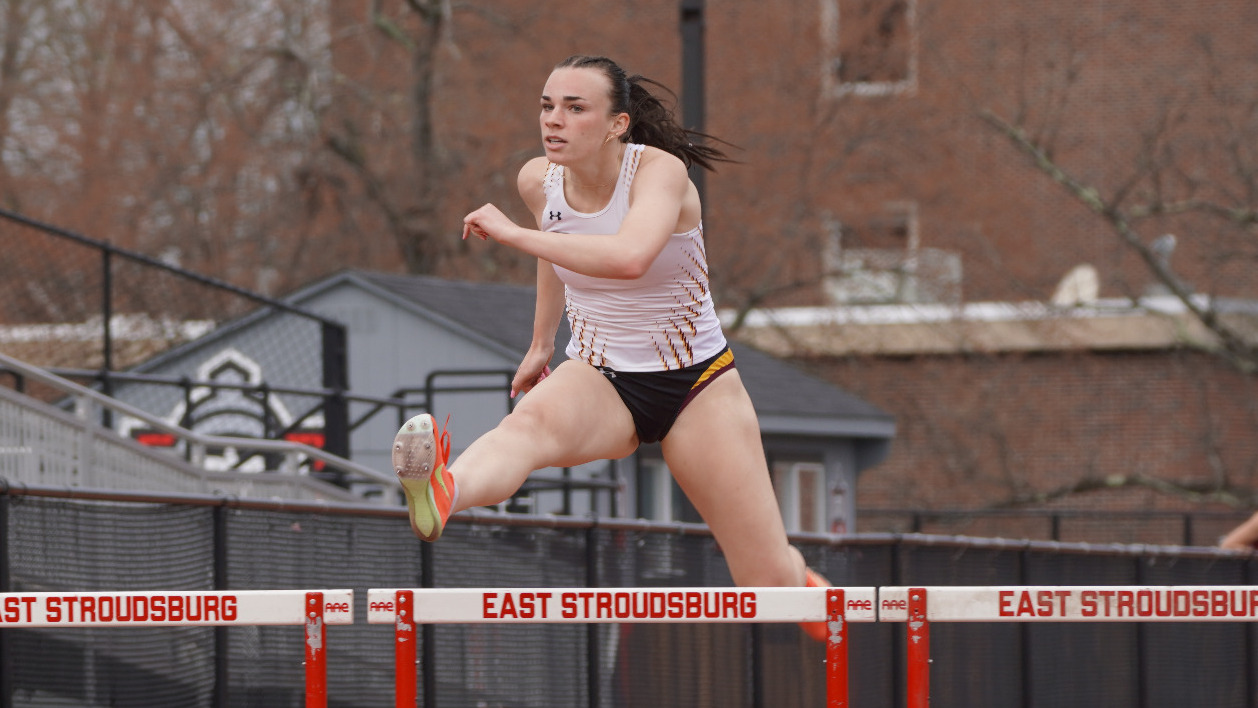 Abby Parise jumps over a hurdle at East Stroudsburg.