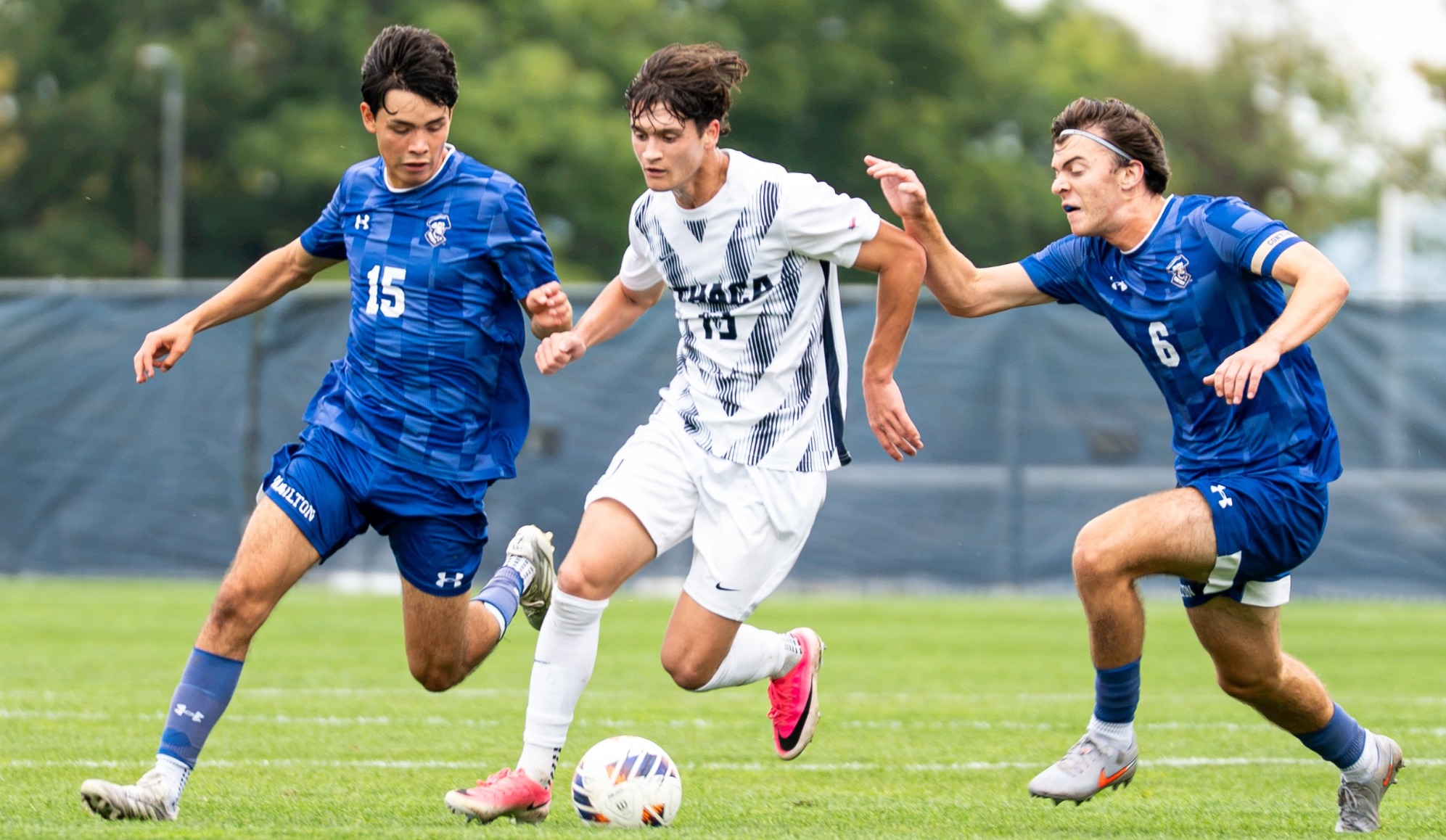 Partenza fights two defenders