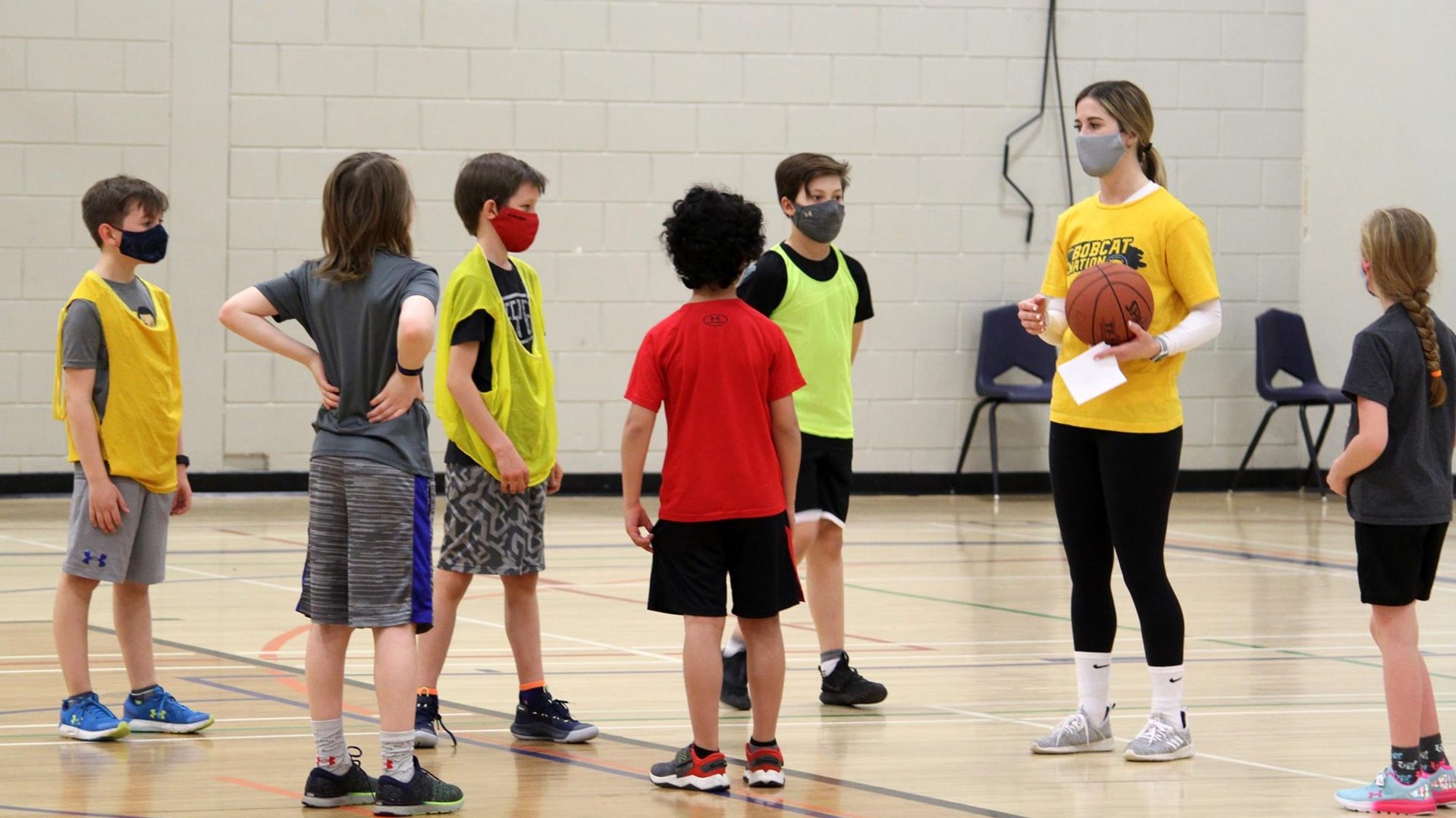 Chelsea Misskey of the Bobcats women's basketball team instructs youth in the Learn and Play basketball session