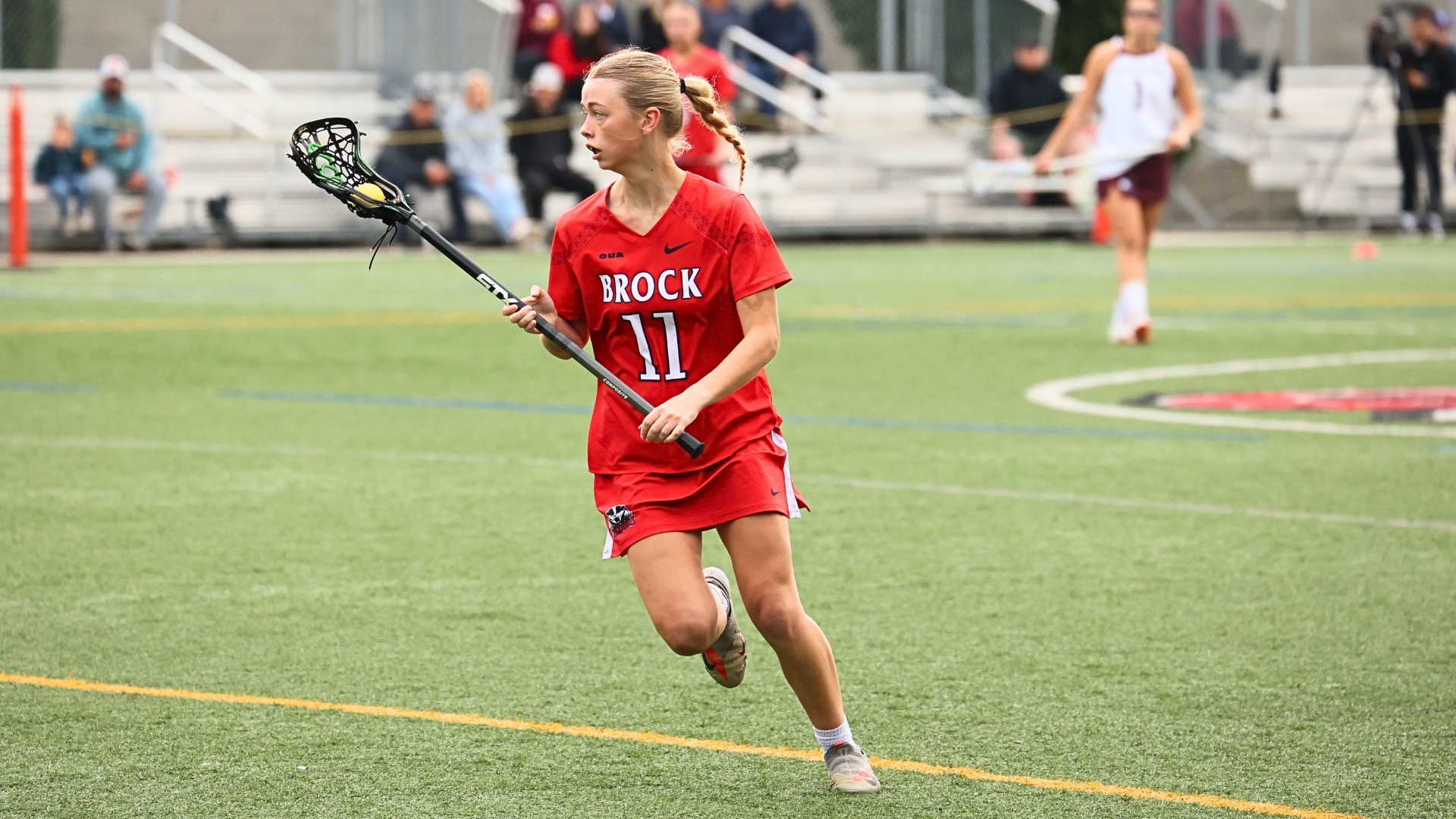 Lucy Lee carrying the ball