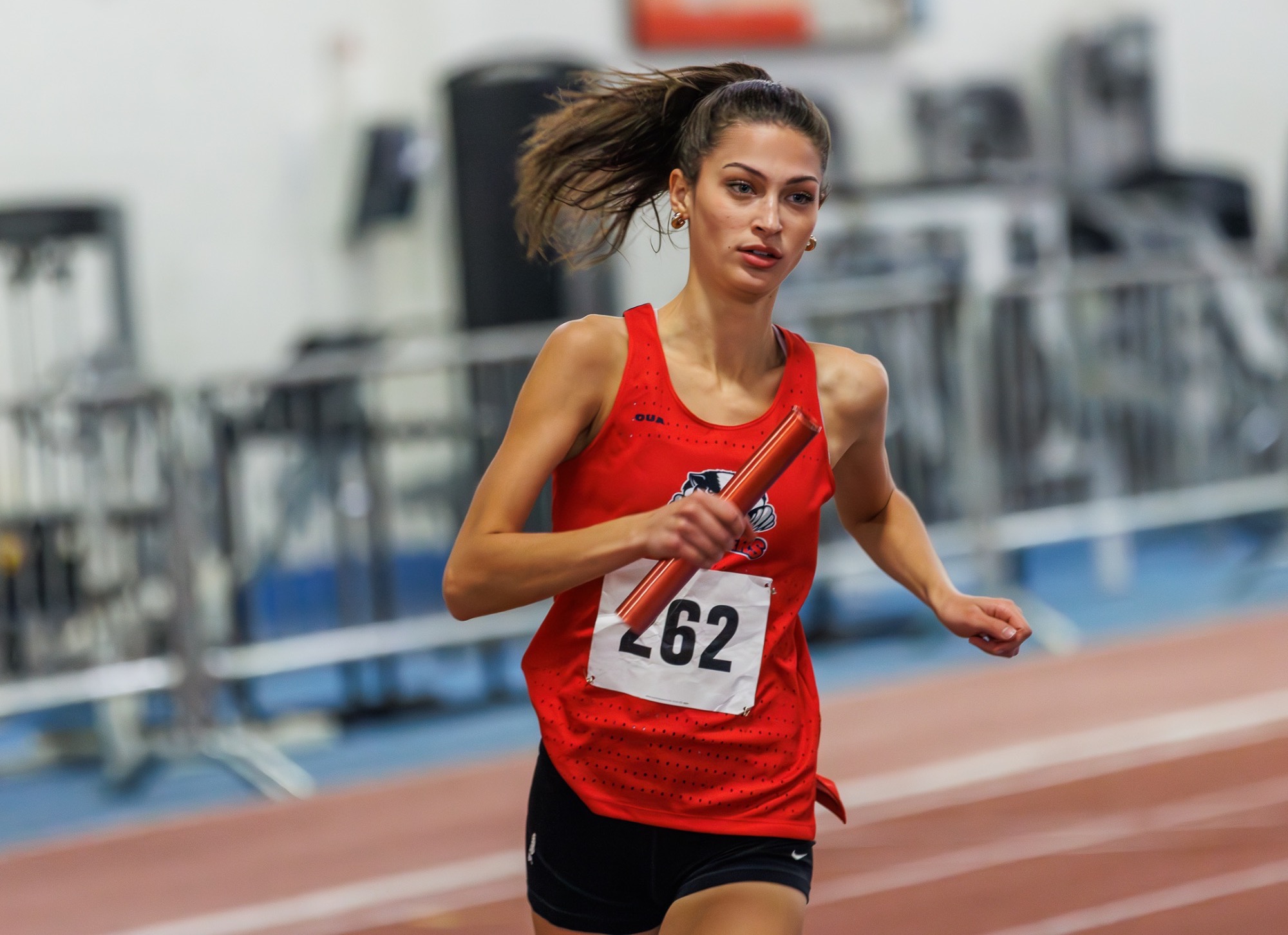 Adeline Steiger running with a baton