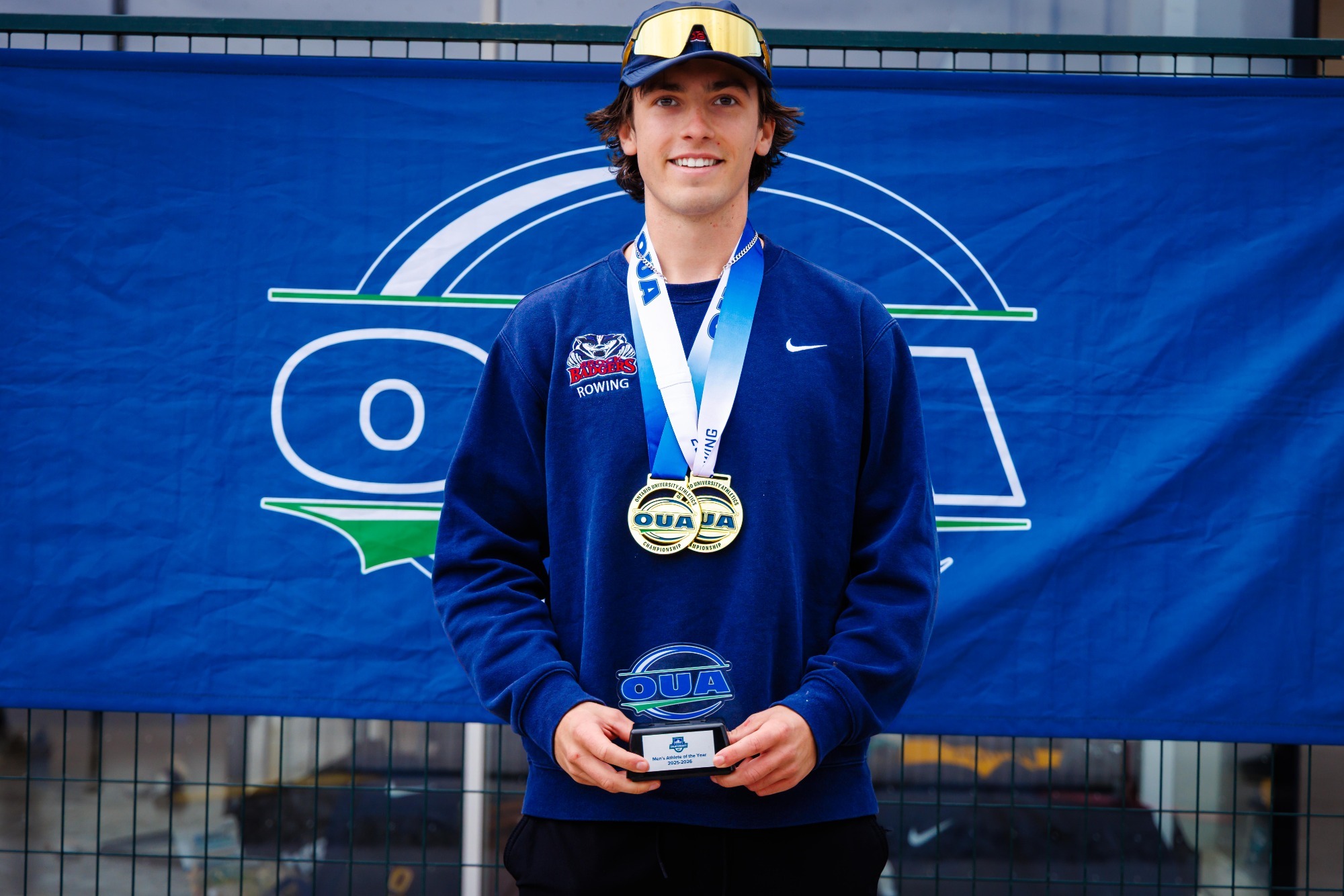 Riley Watson pictured with the OUA Men's Rower of the Year award