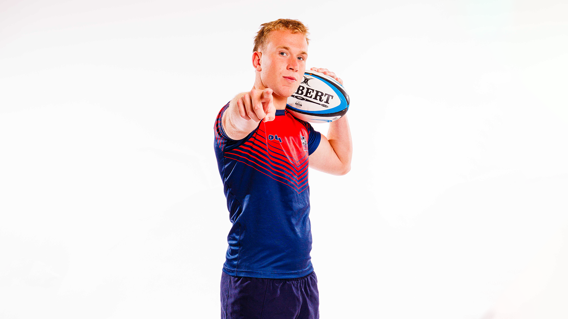 Koen Schroeder, a Brock men's rugby player pointing with this right hand in a media day photo