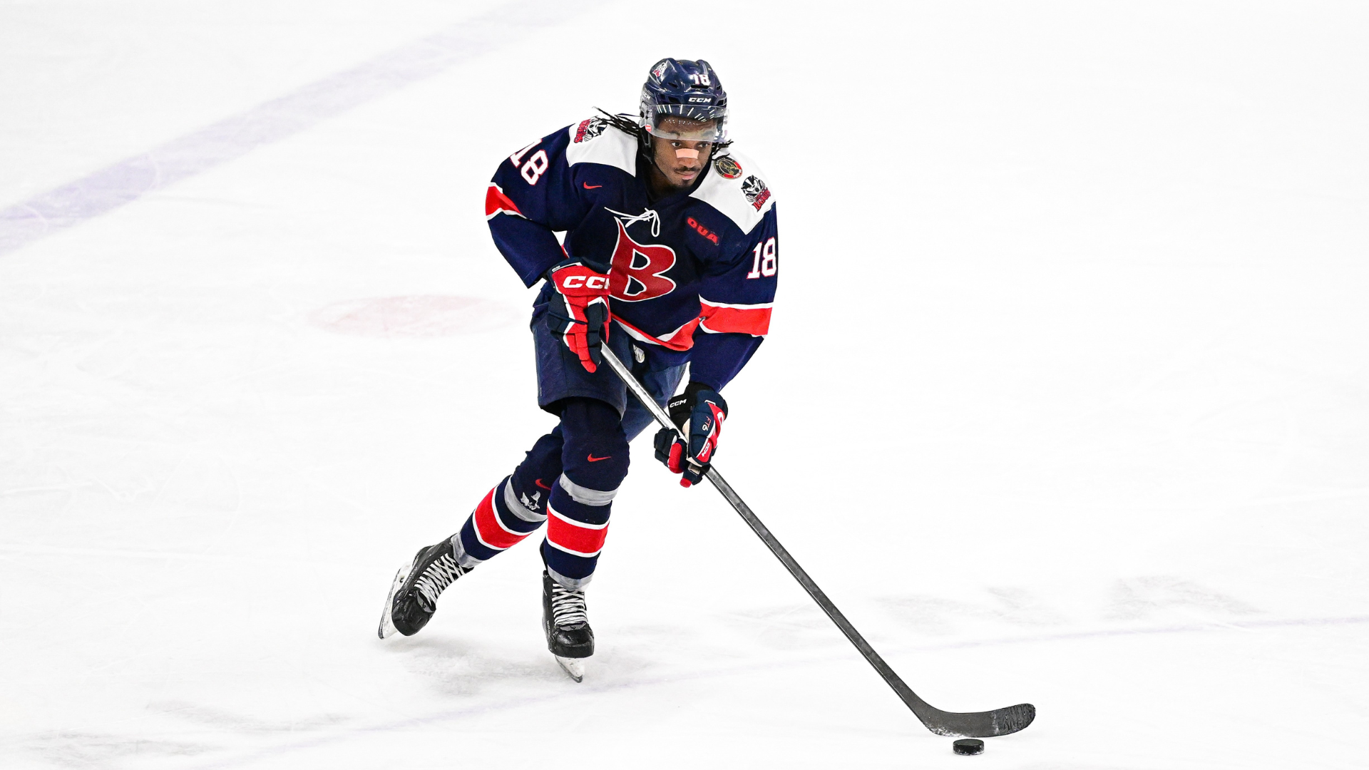 Zack Stringer stick handling with the puck