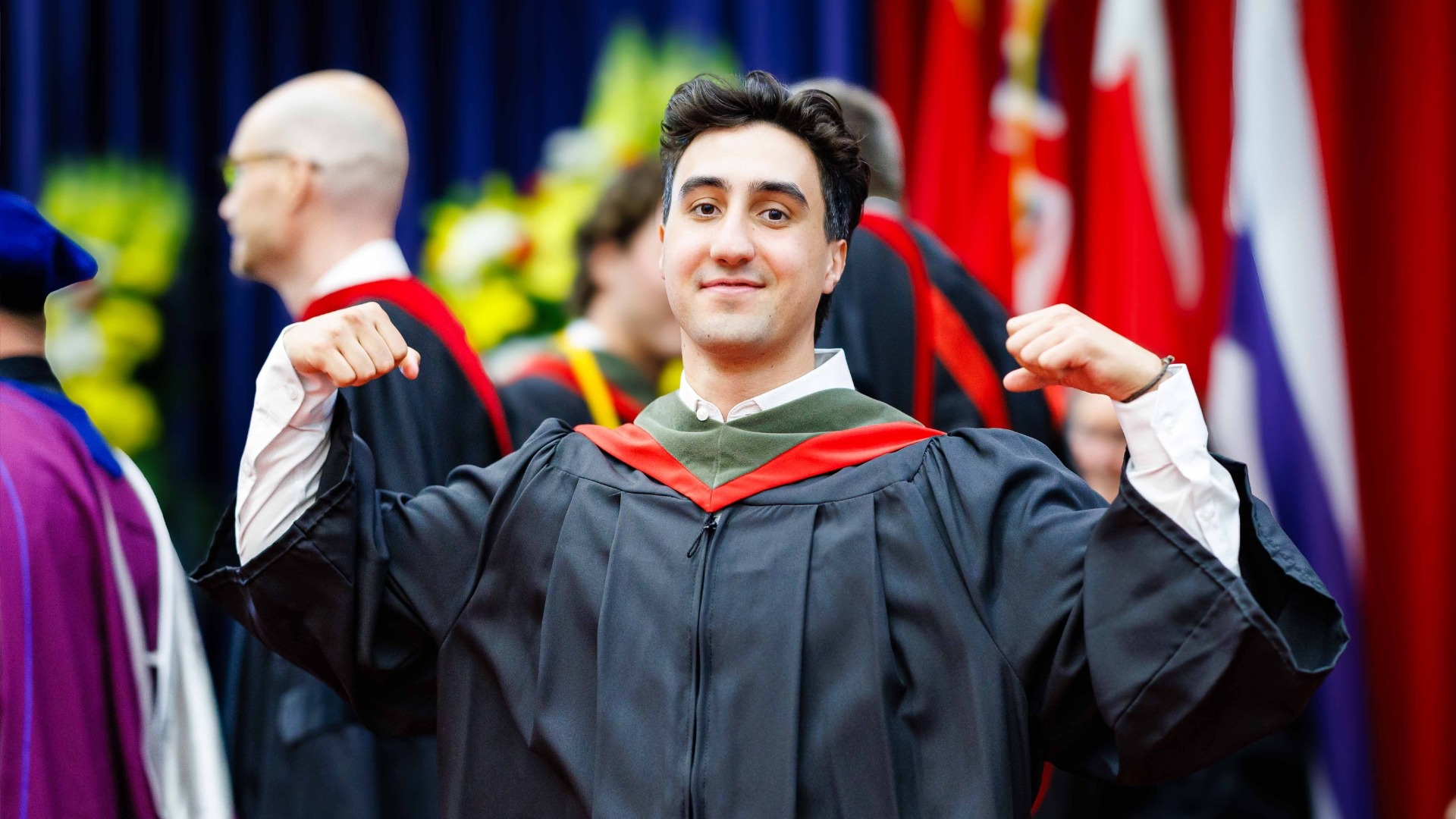 Chris Gomez flexing at 2025 Convocation