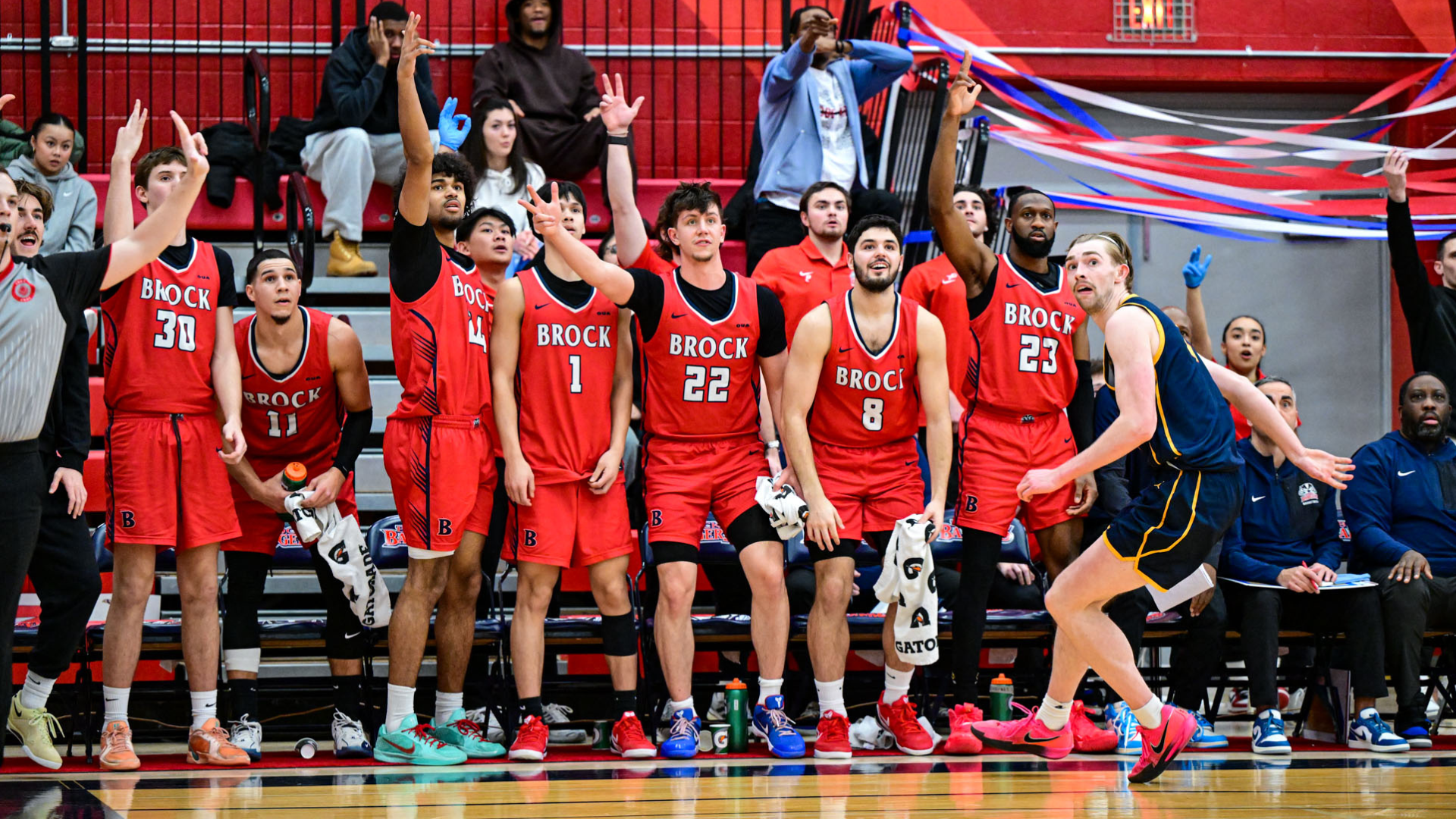 The Brock men's basketball team celebrates against the Queen's Gaels on Saturday, Jan. 24 at Bob Davis Gymnasium.