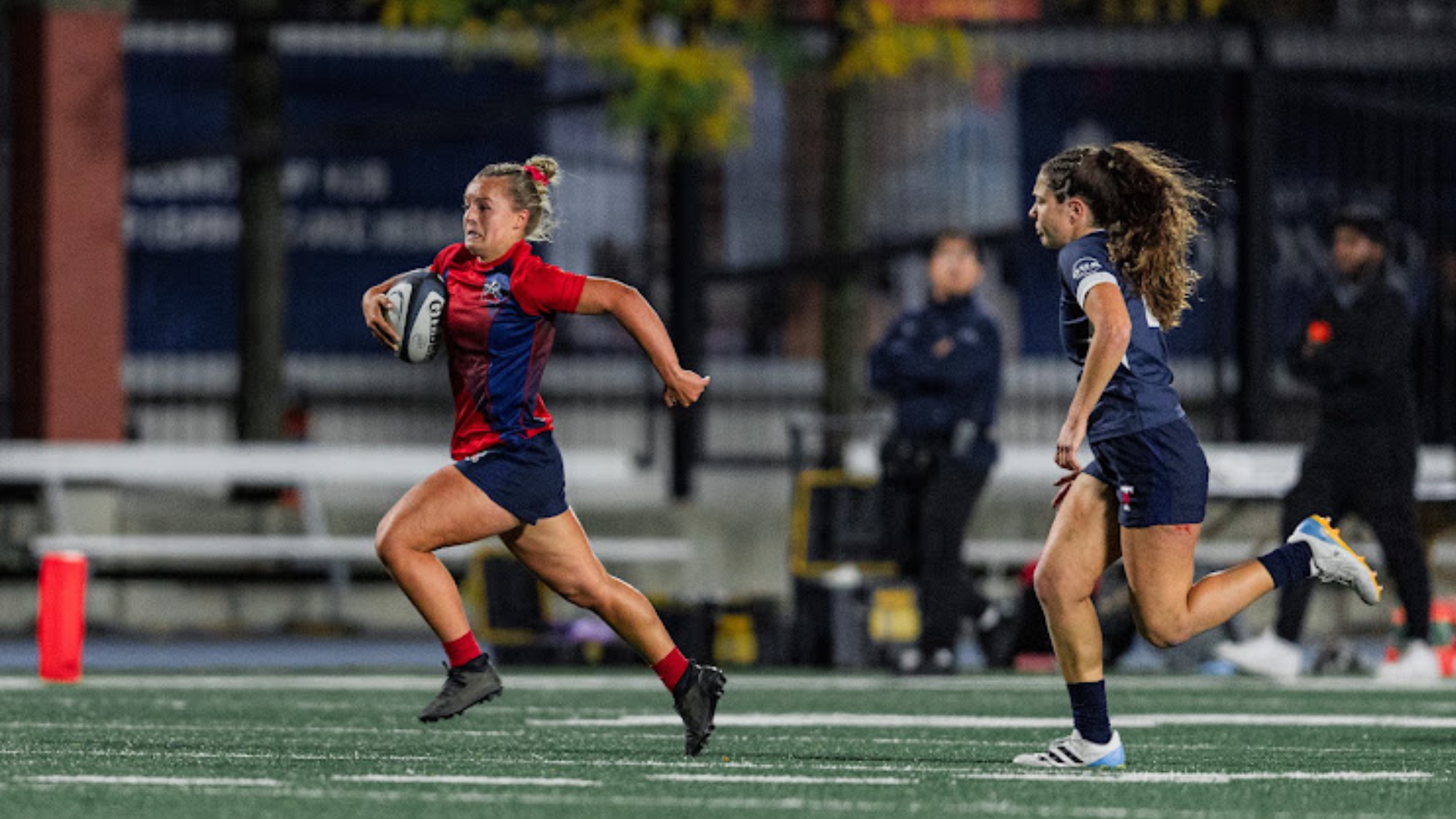 A Brock women's rugby player runs towards the try zone