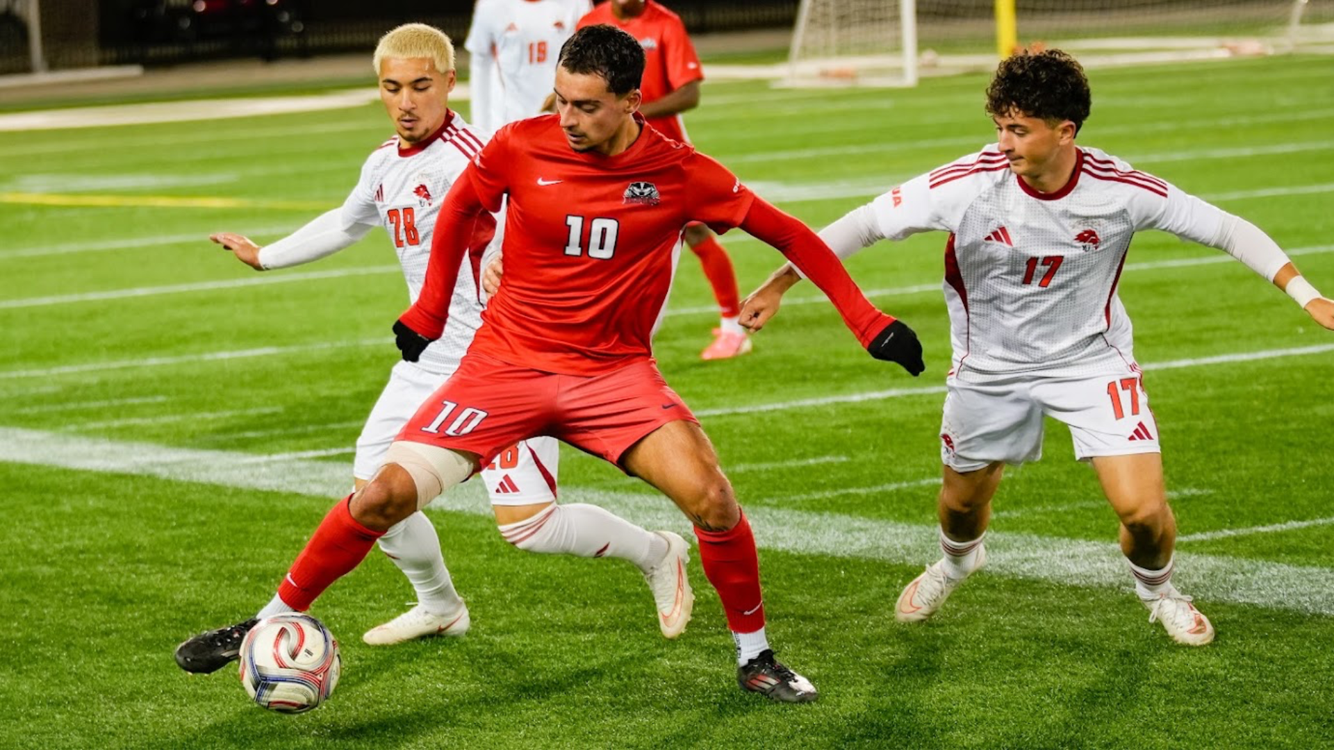 A Brock men's soccer player fights to keep possession of the ball