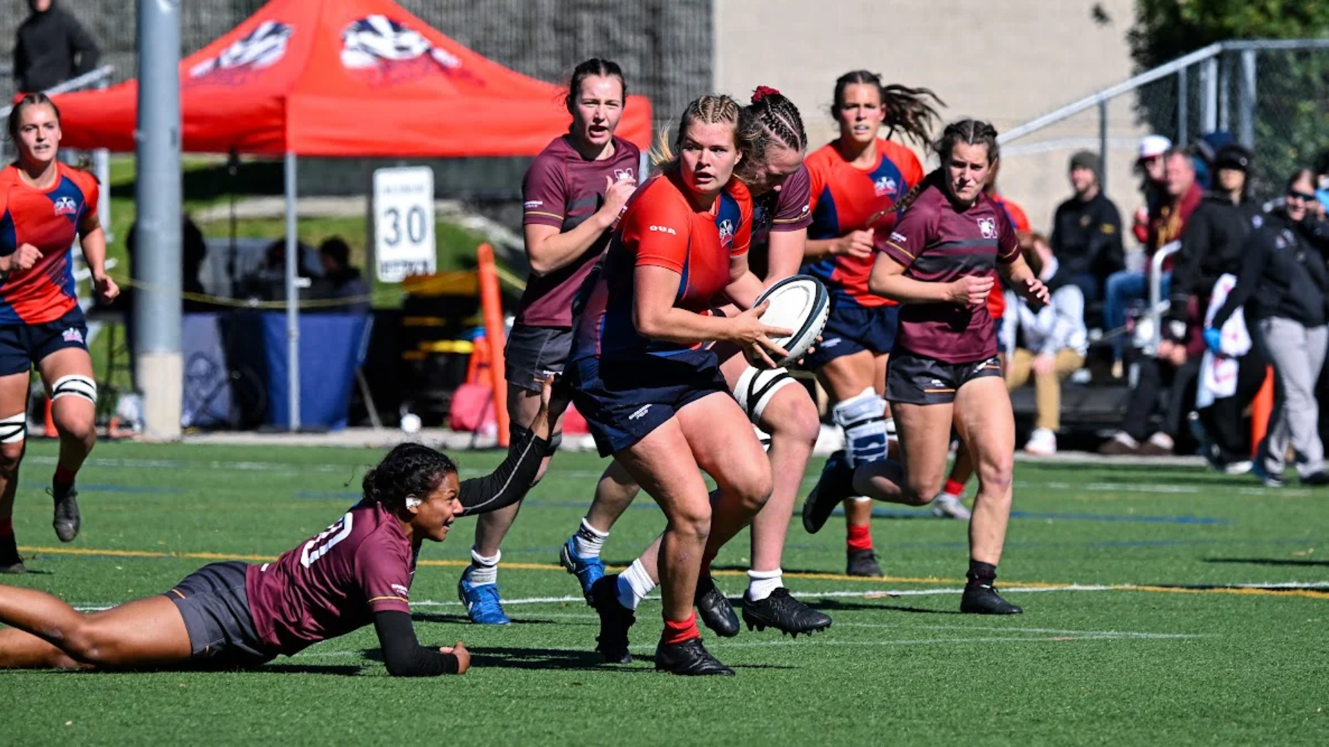 A Brock women's rugby player evades a tackle 