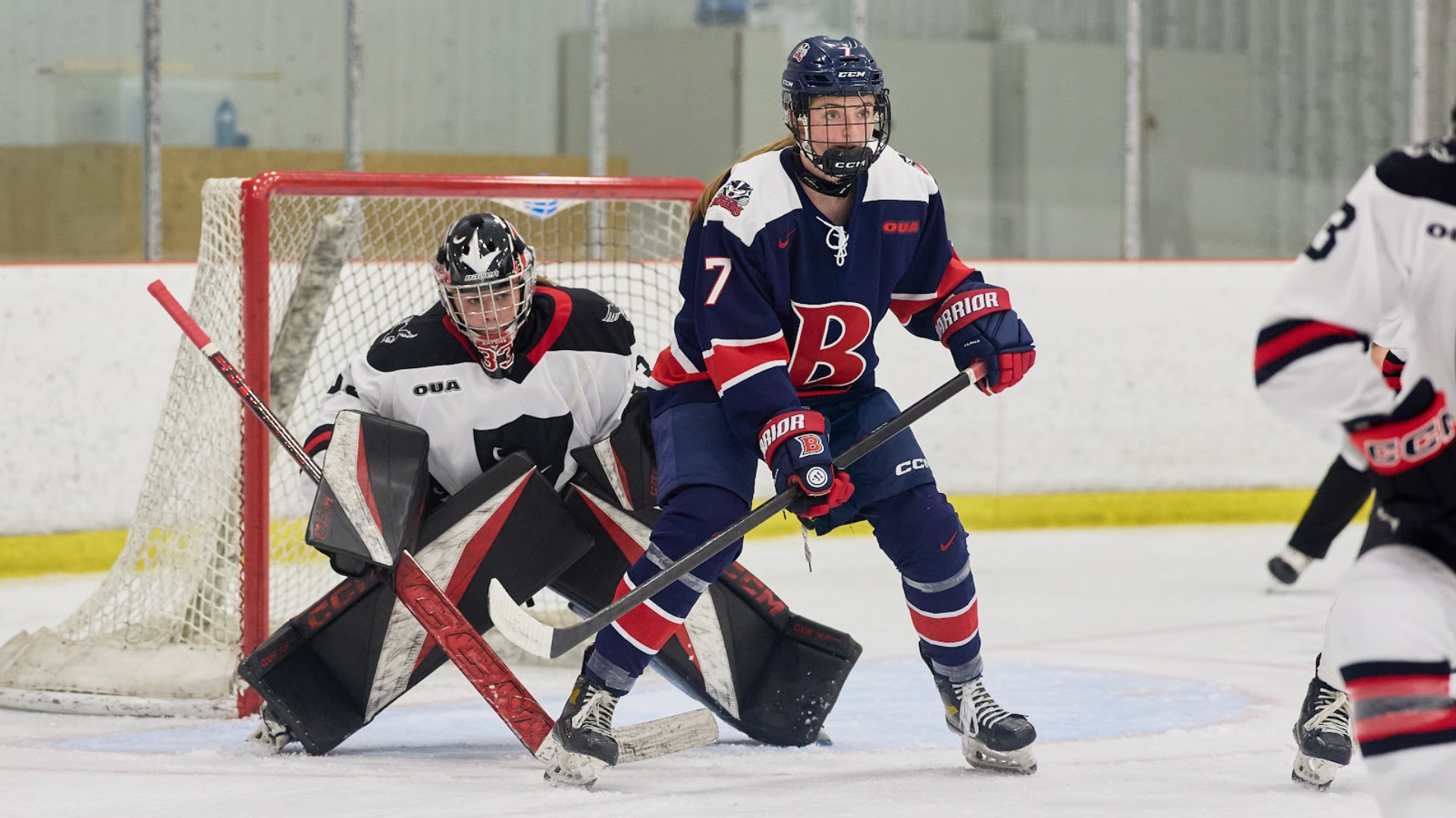 A Brock women's hockey player blocks the vision of the opposition goaltender