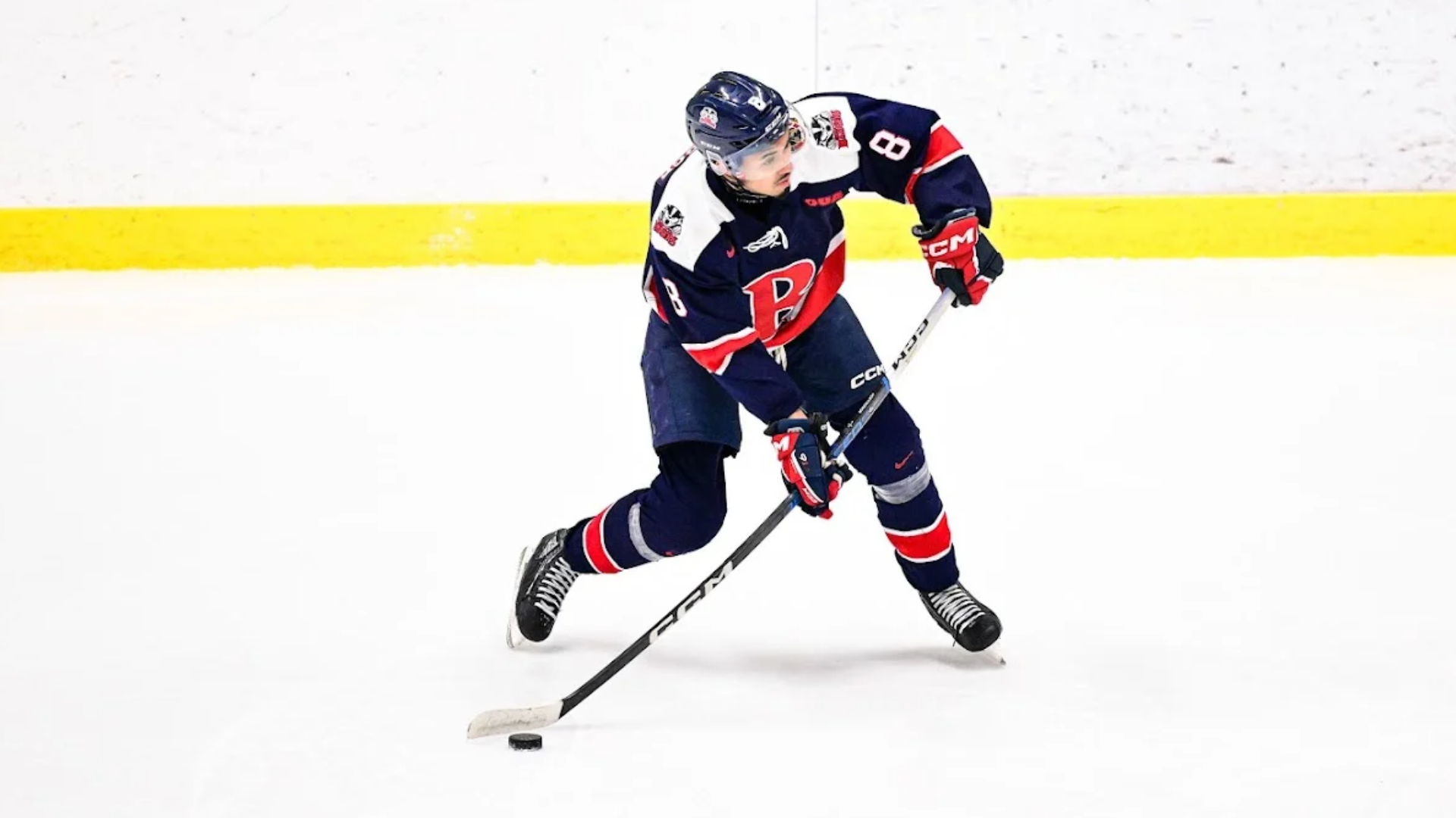 A Brock men's hockey player shoots the puck