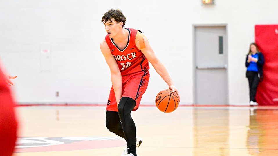 Andrew McKenna dribbles the ball between his legs