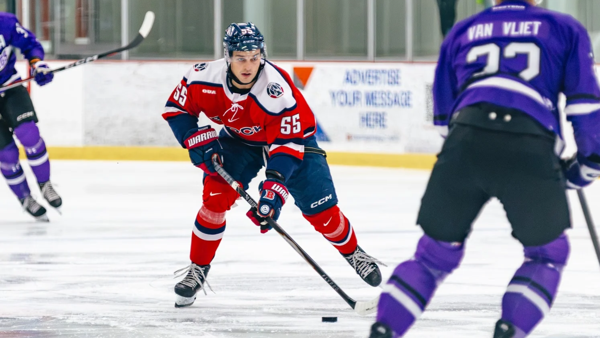 A Brock men's hockey play drives the puck up the ice