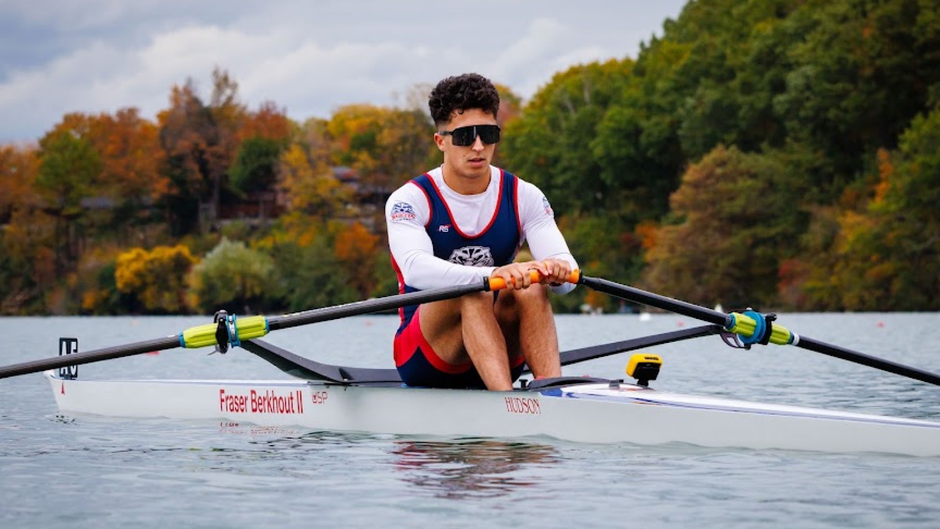 A Brock men's rowing player rows forward in competiton
