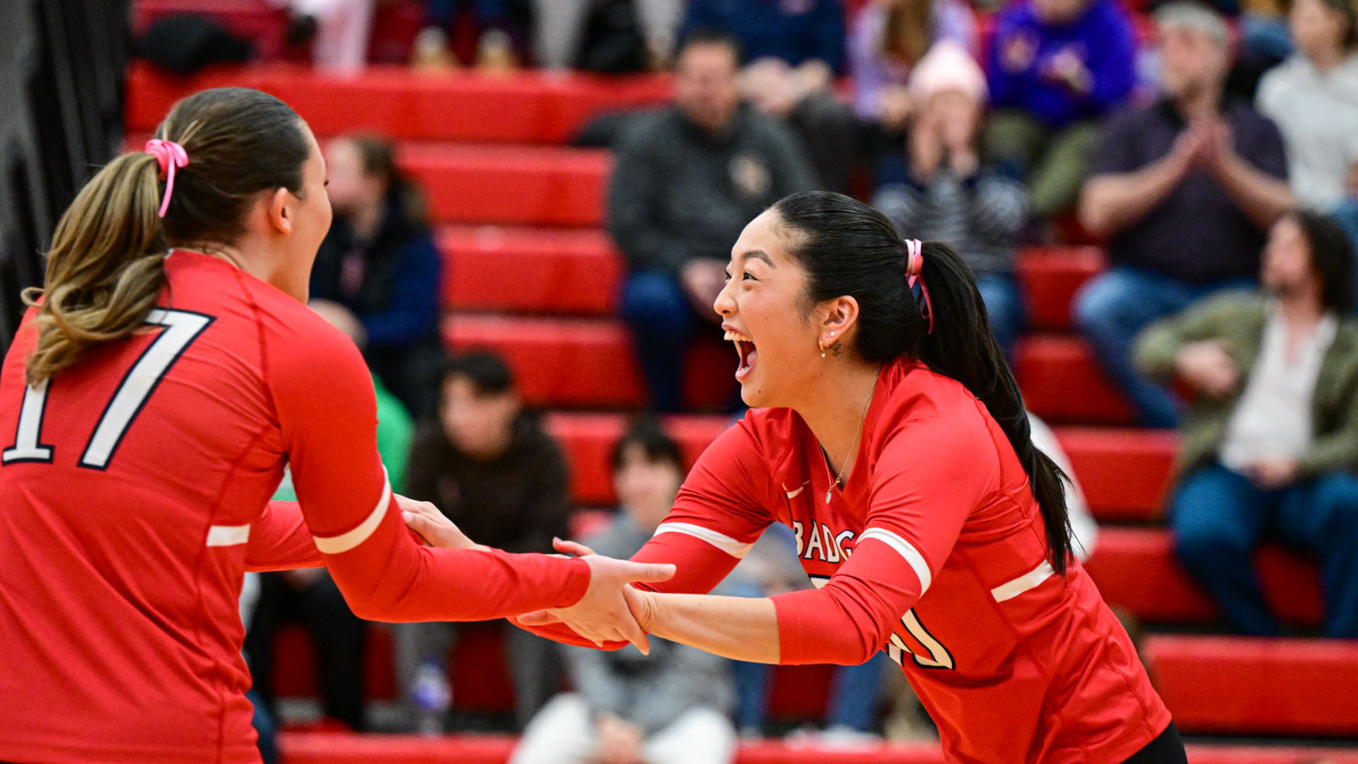Emma Baruchelli and Kara Rakamnuayki, two Brock women's volleyball players celebrating a point in OUA action