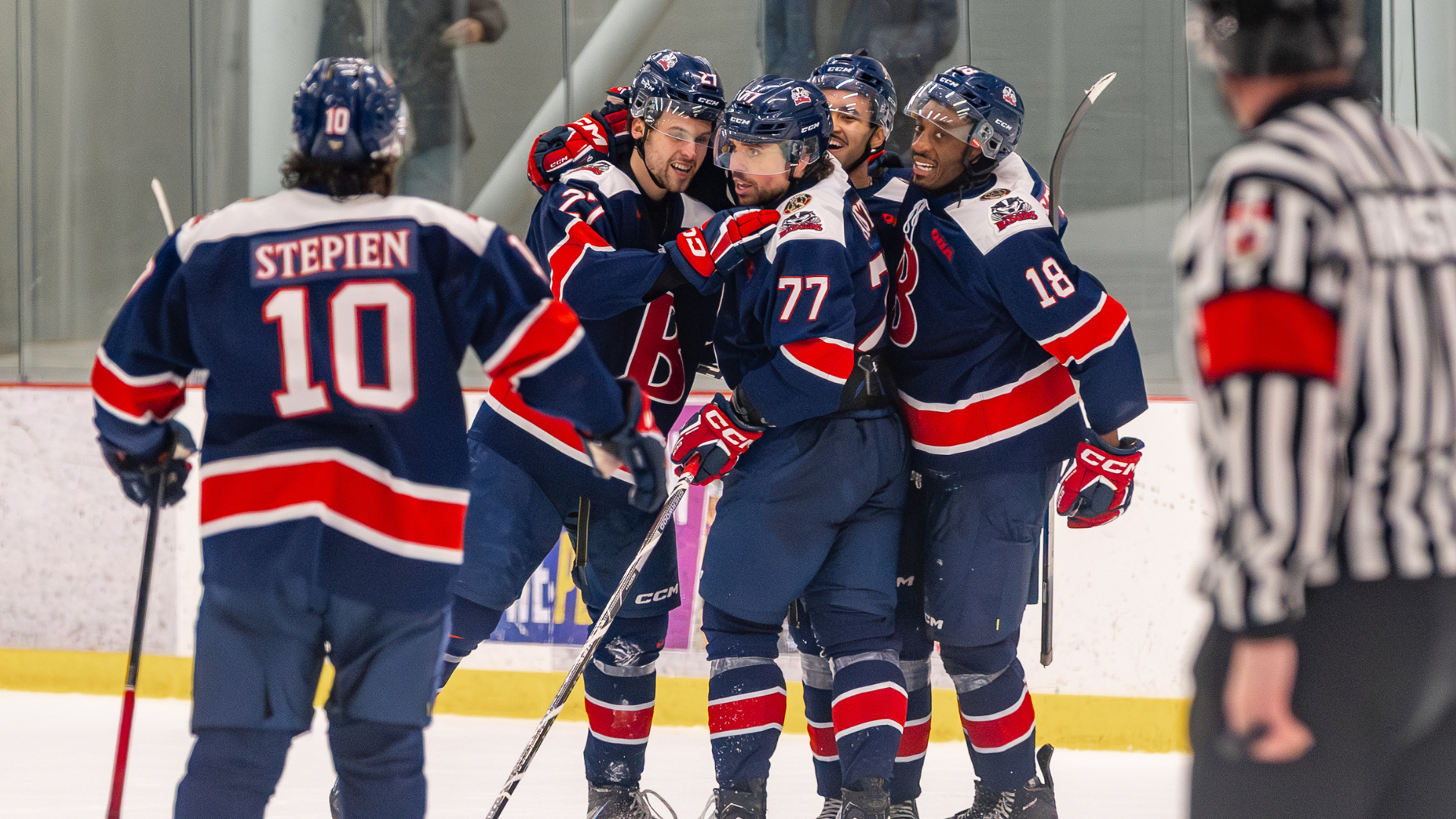 The Brock Badgers men's hockey team celebrate with Alexis Cournoyer after he scored the game winning goal of Game 2 of the OUA Quarterfinals
