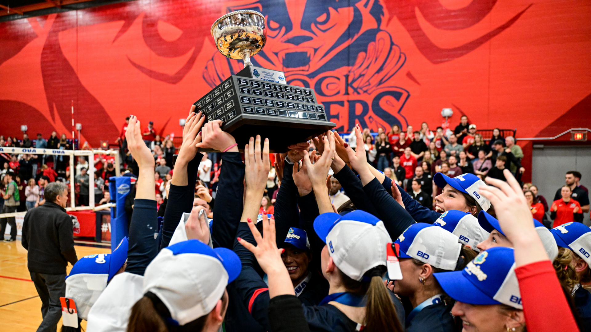 The Brock Badgers women's volleyball celebrates with the Quigley Cup trophy on Friday, March 6 at Bob Davis Gymnasium.