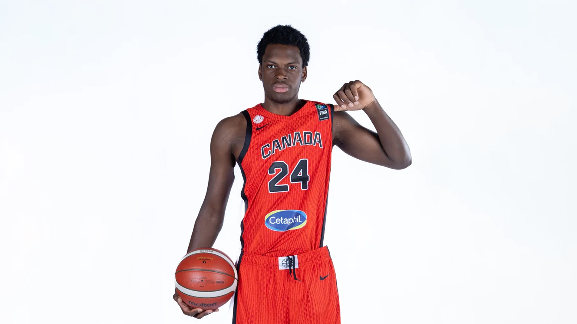 Emmanuel Oko-Oboh pictured in a media day photo with a Team Canada jersey