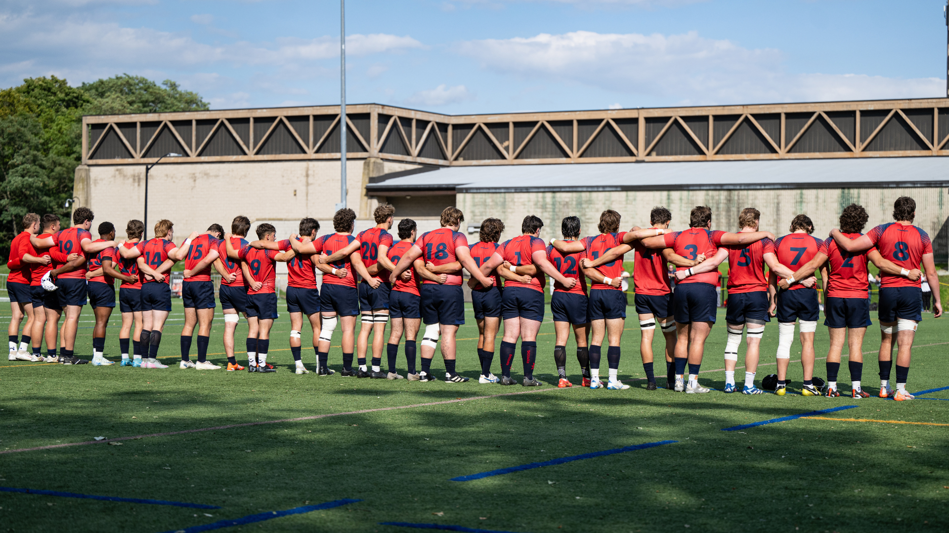 Men's rugby team lined up before a game
