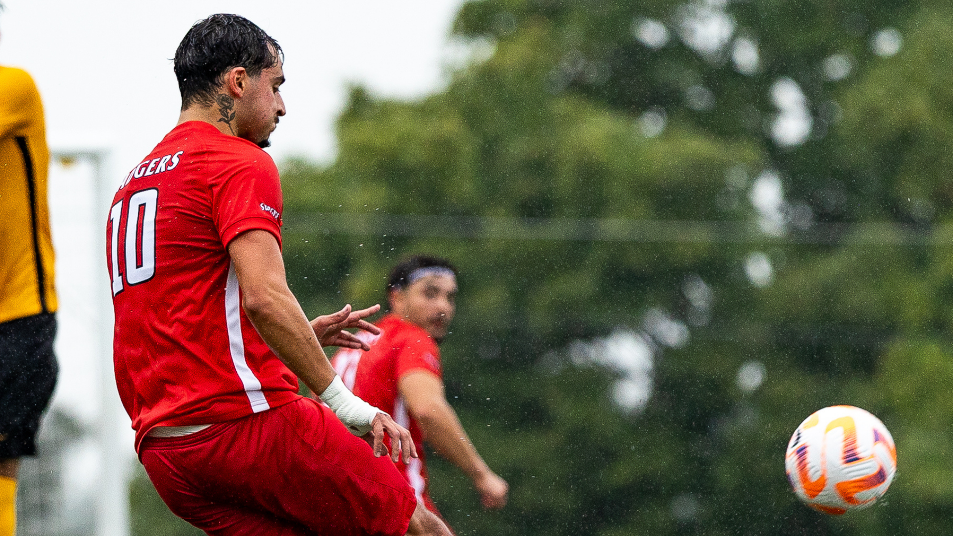 A Brock men's soccer player crossing the ball