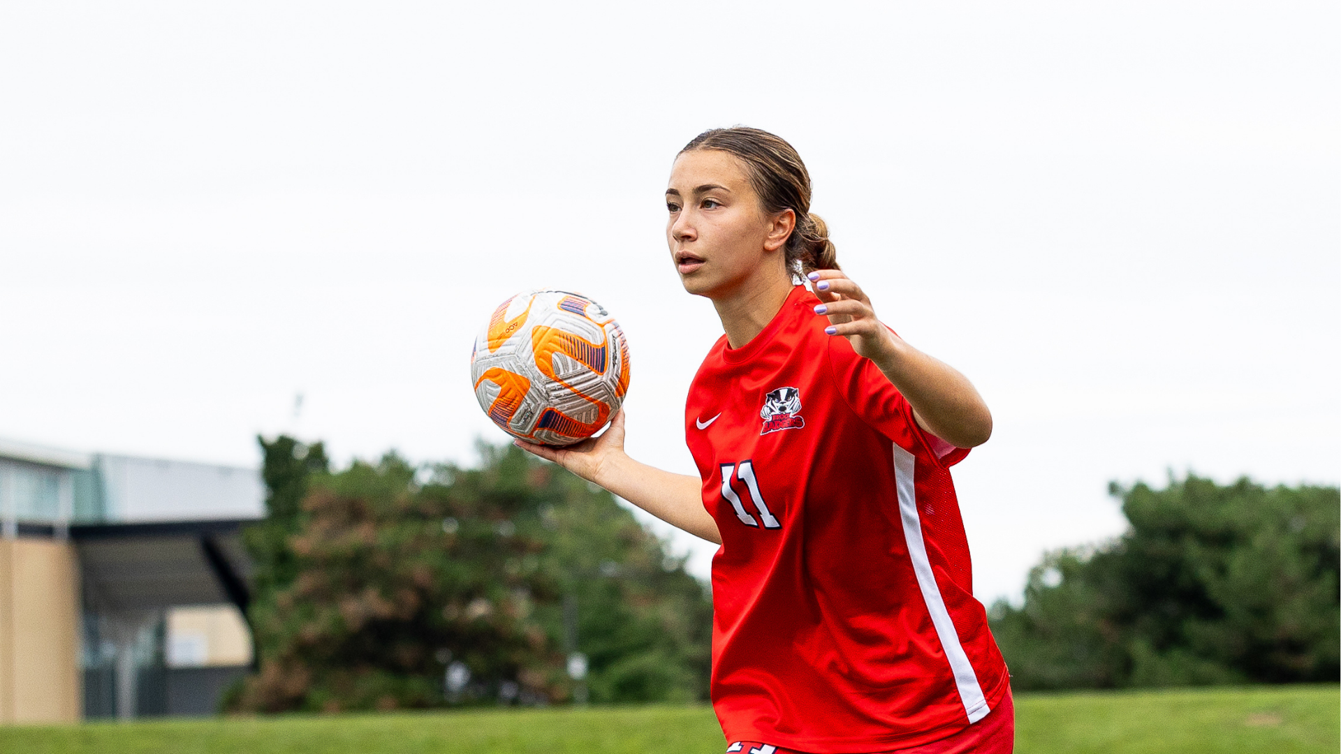 A Brok women's soccer player throwing the ball
