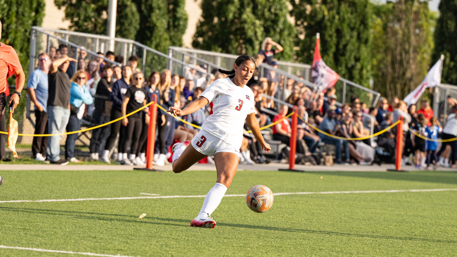 A Brock women's soccer player dribbles the ball forward