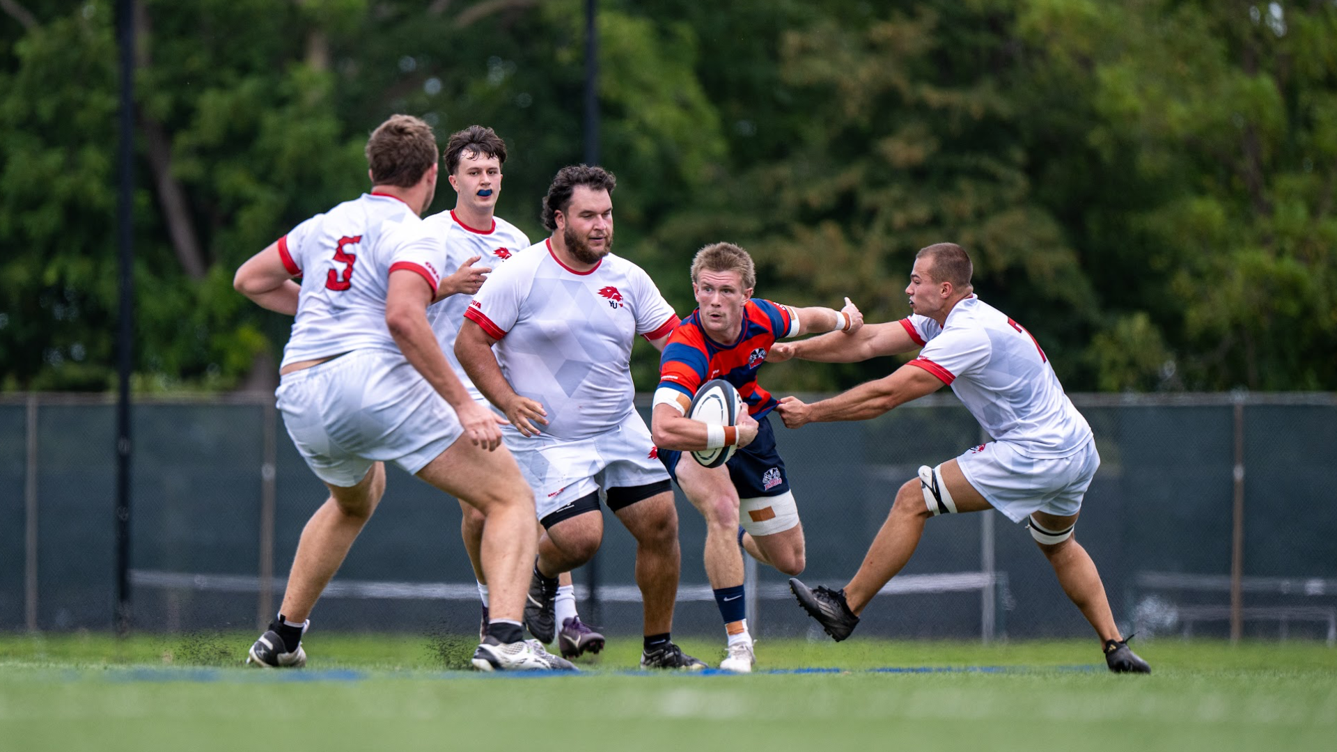 A Brock men's rugby player escapes tacklers
