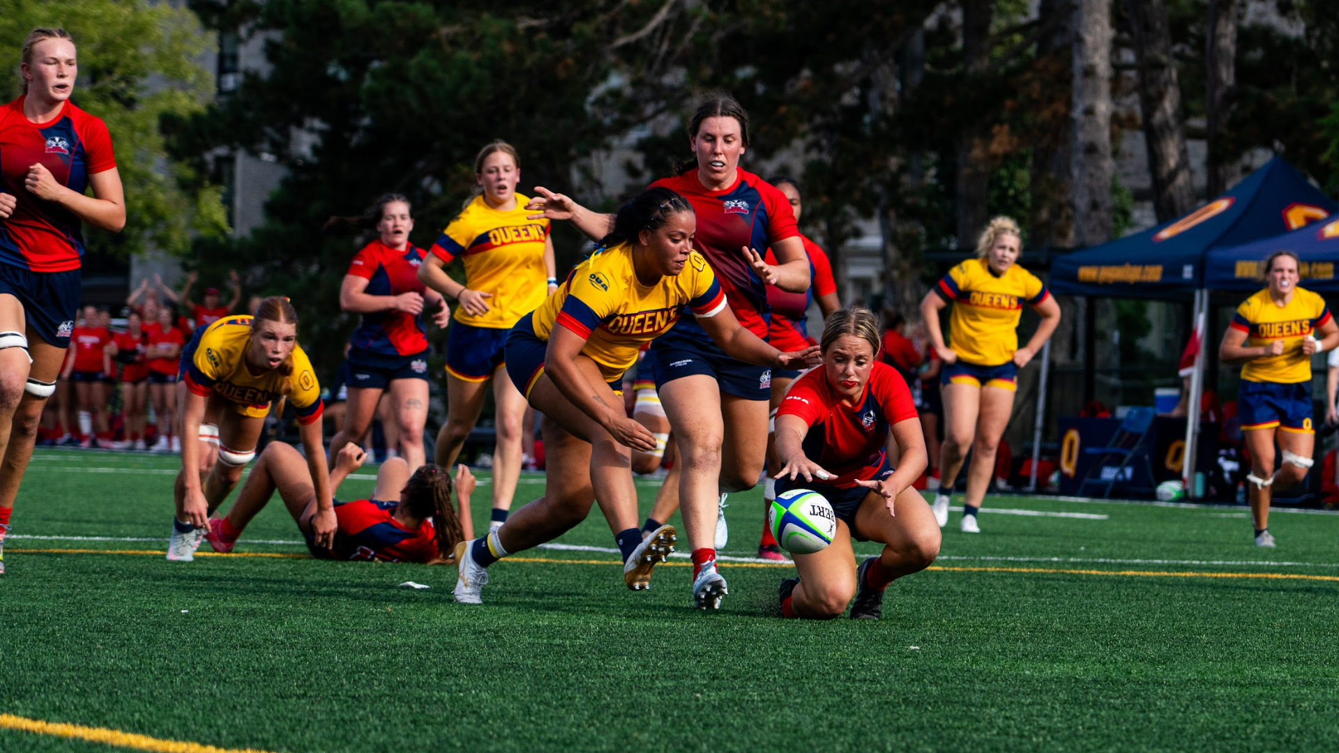 A Brock Badgers women's rugby player fights for a loose ball
